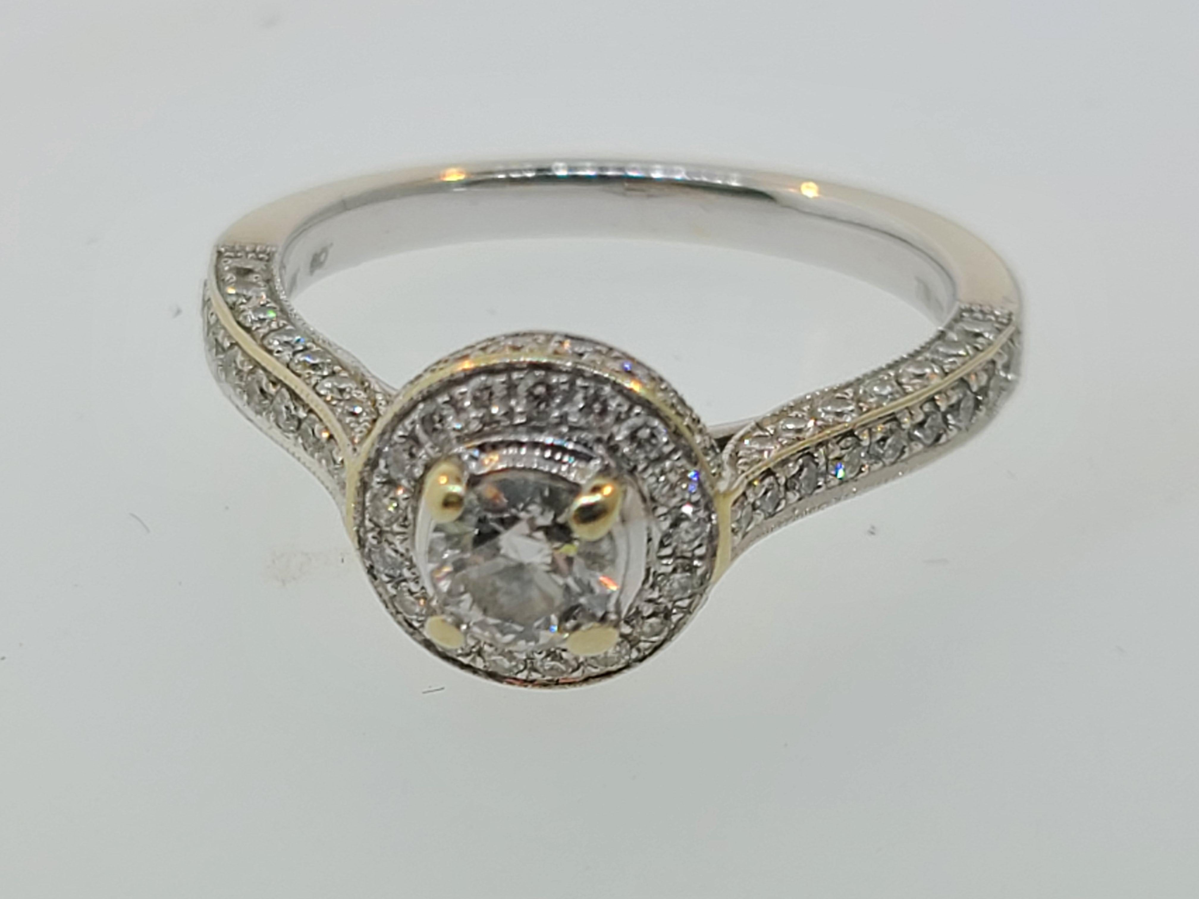 This contemporary halo diamond engagement ring is set in 14K white gold with a 4.3mm main stone and accent diamonds totaling 7/8ct total weight.

Ring Size 6.5 (US)
Total weight is 3.5 grams. 
There is some wear to the rhodium plating.