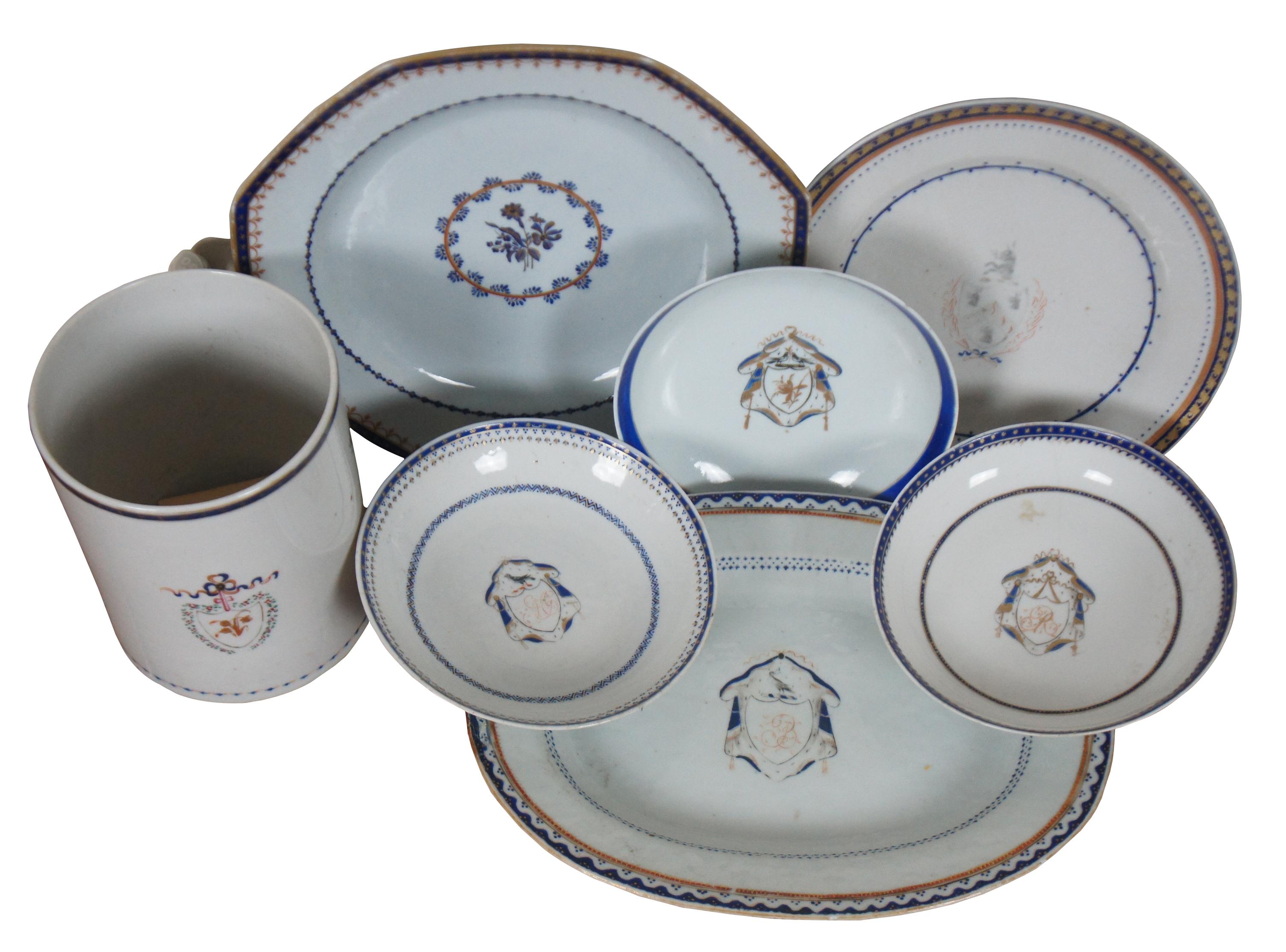 Lot of seven late 18th to early 19th century Chinese Export (Qianlong Period, circa 1780) porcelain pieces in an American federal style with blue and gold motifs and armorial crest coats of arms. Features hexagonal charger or dinner plate, oval