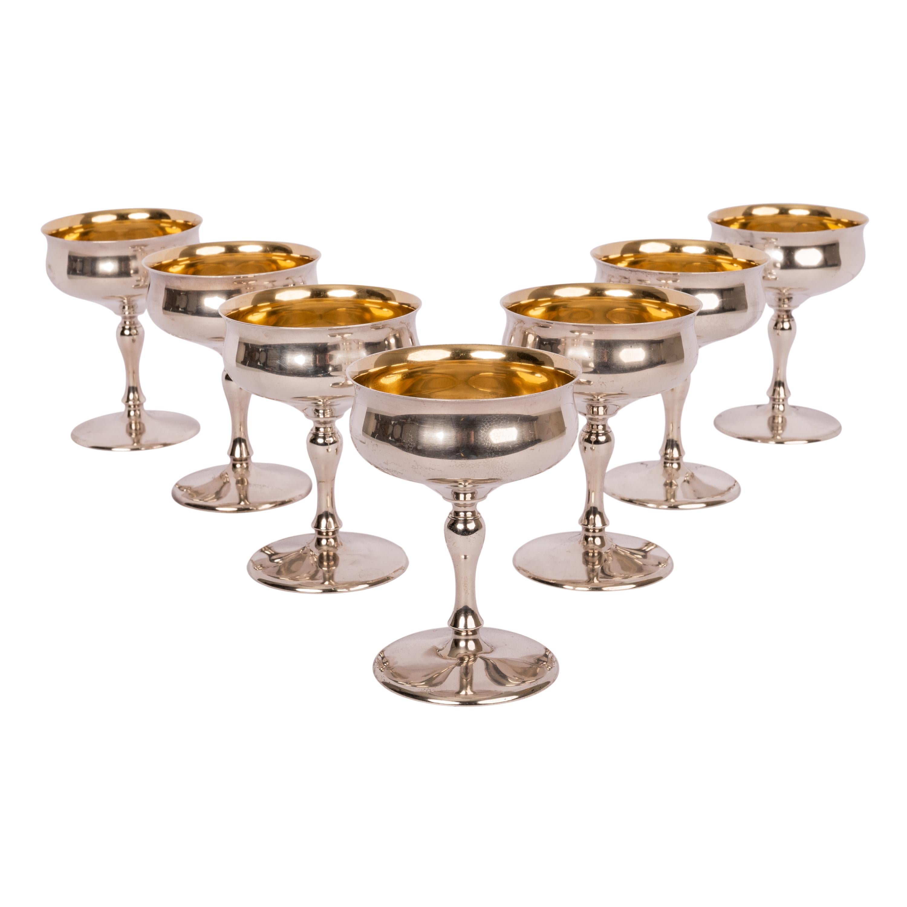 A good set of antique American sterling silver gilt sherbets/ wine goblets, by Reed & Barton, circa 1928.
Each goblet is made of solid sterling silver with a flared bowl and having gilt interiors, the goblets are raised on baluster shaped stems and