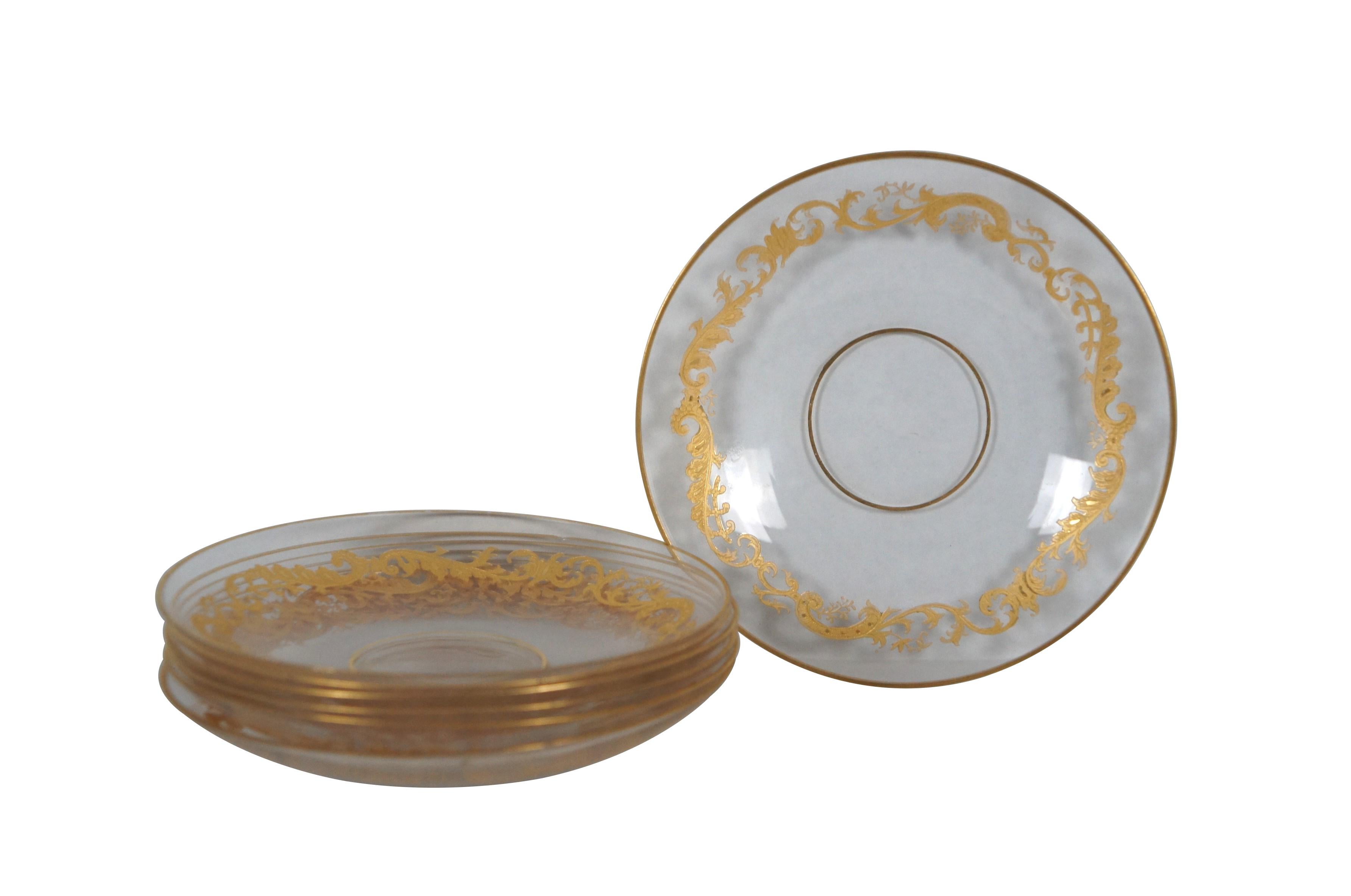 Set of seven 20th century clear crystal / glass and gold encrusted dessert fruit underplates / saucers, featuring gold rims and etched / gilded design of swirling leaves. Attributed to Saint Louis - France.

Dimensions:
5.25