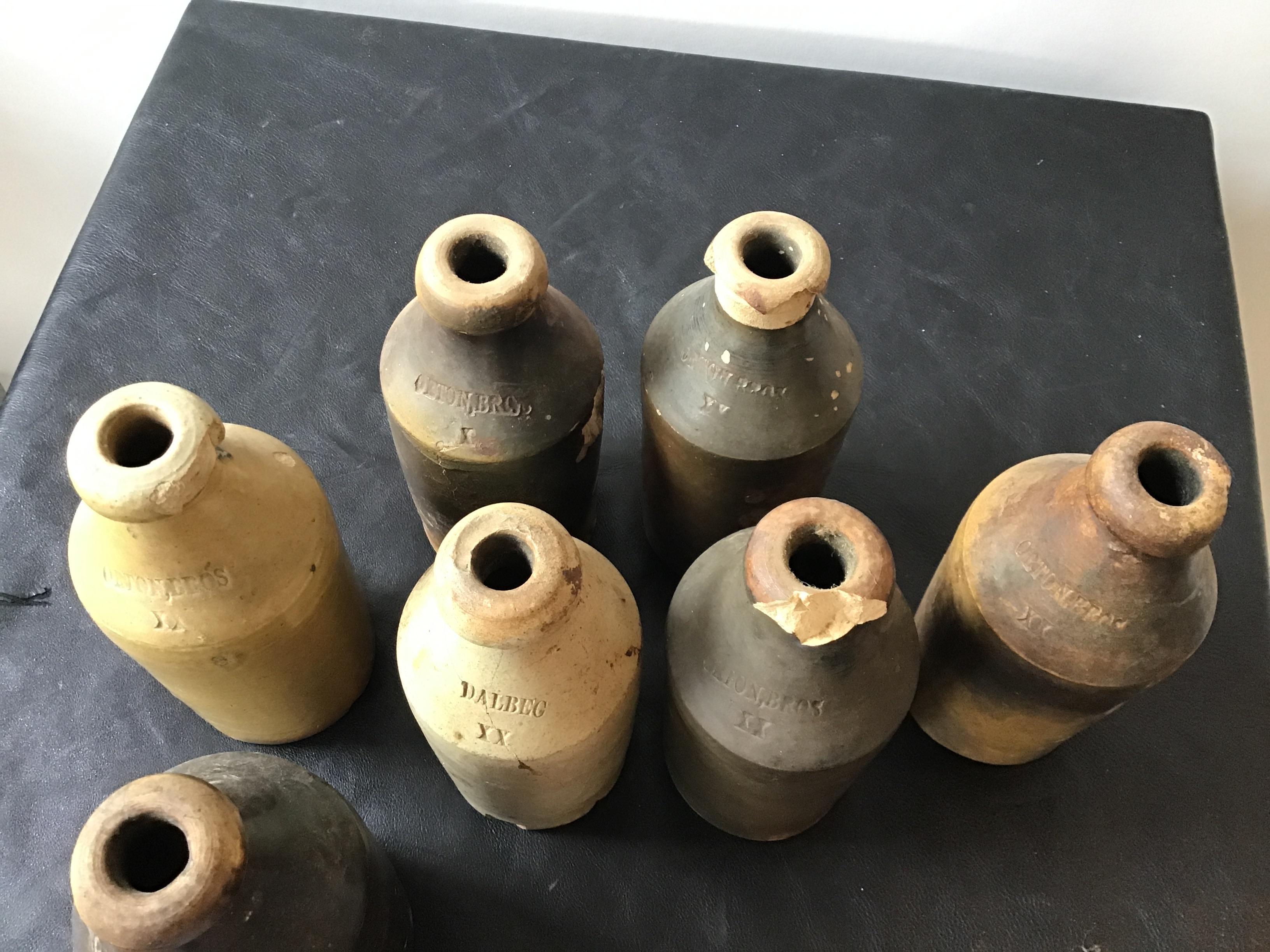7 Antique Stoneware Gin Bottles 1
