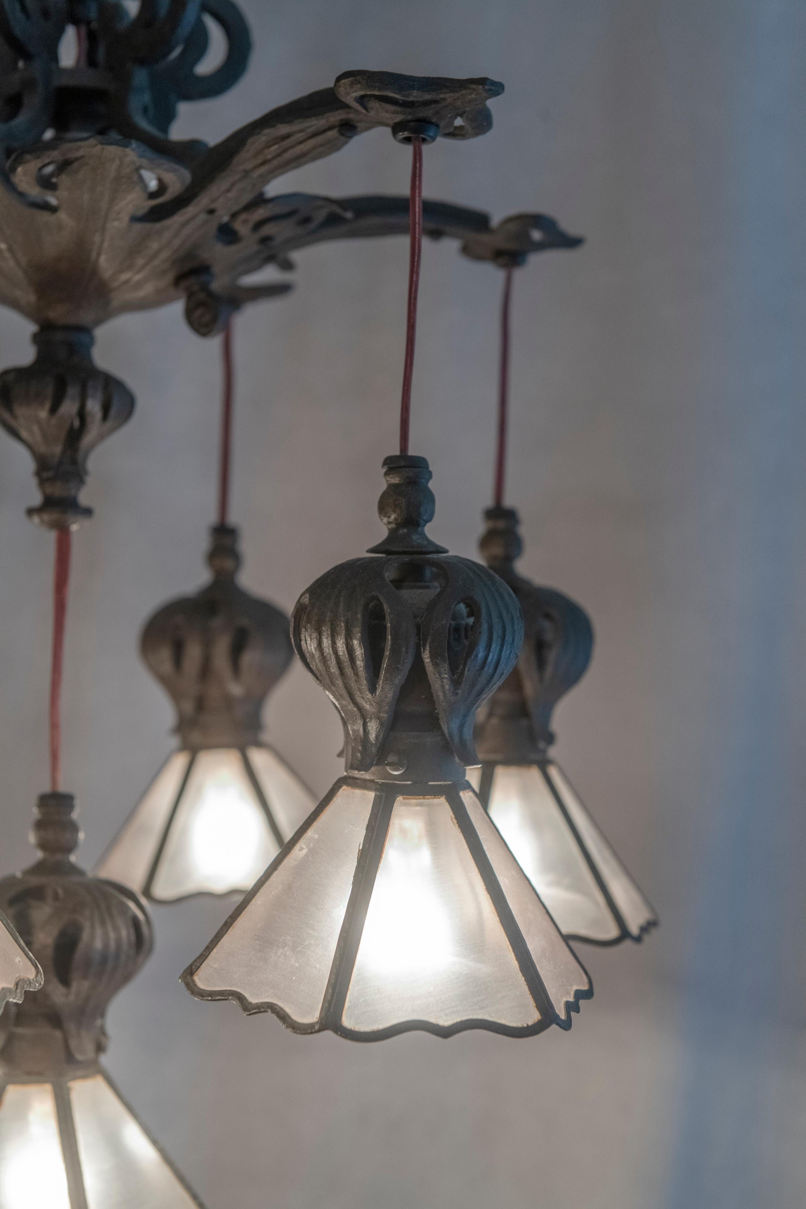 This exceptional 7 light chandelier is one great light. It has much to offer. For starters it is American, and you don't see much commitment to art nouveau lighting of this quality that isn't Austrian or French. If you look at the measurements it is
