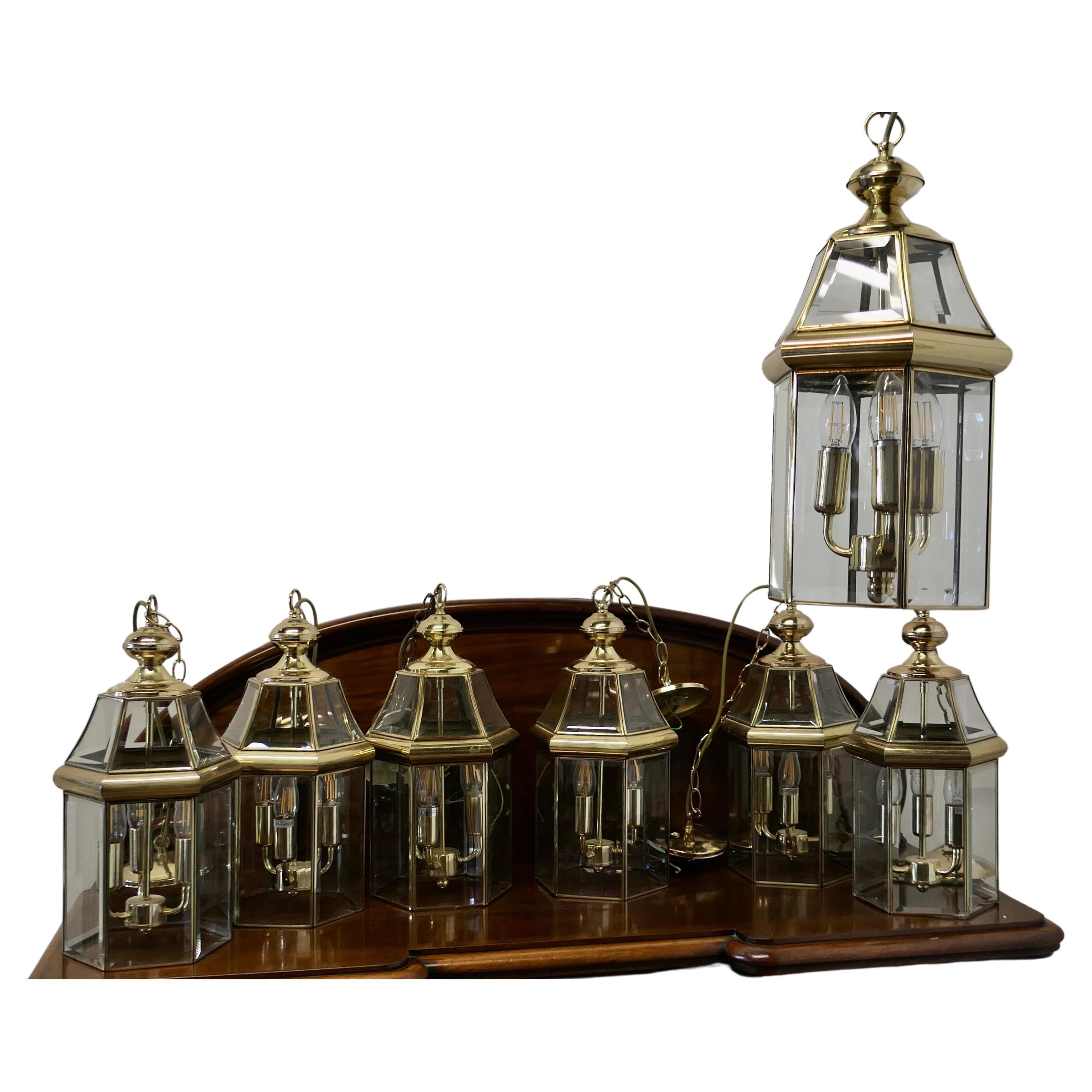  7 Art Deco Style Brass & Glass Hall Lanterns

A superb impressive set of brass lanterns, these have 6 clear glass sides set with bevelled cut glass there are 3 bulb holders inside of each one, they each hang on a brass chain and ceiling rose
The