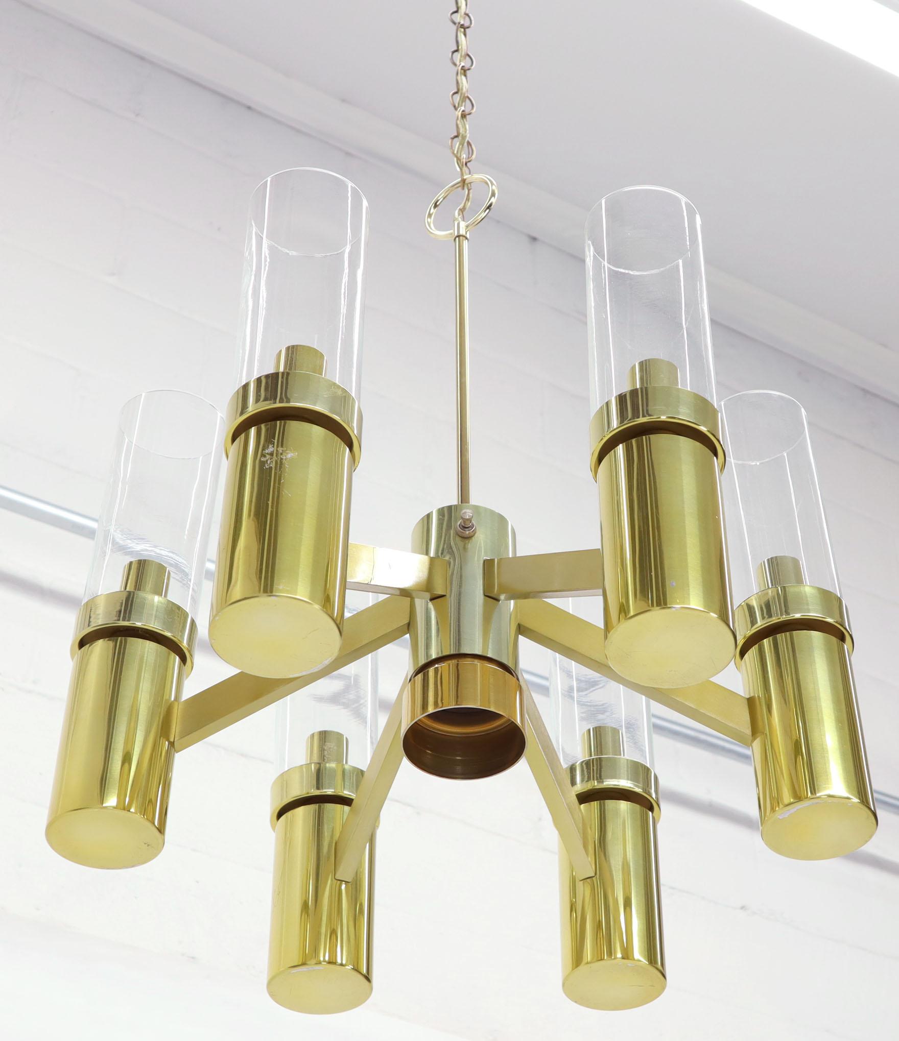 Midcentury Italian modern brass and glass 3 way chandelier. The switch in the centre creates three option: all seven light lit together, one build in the centre (pointing downwards), and the six 
