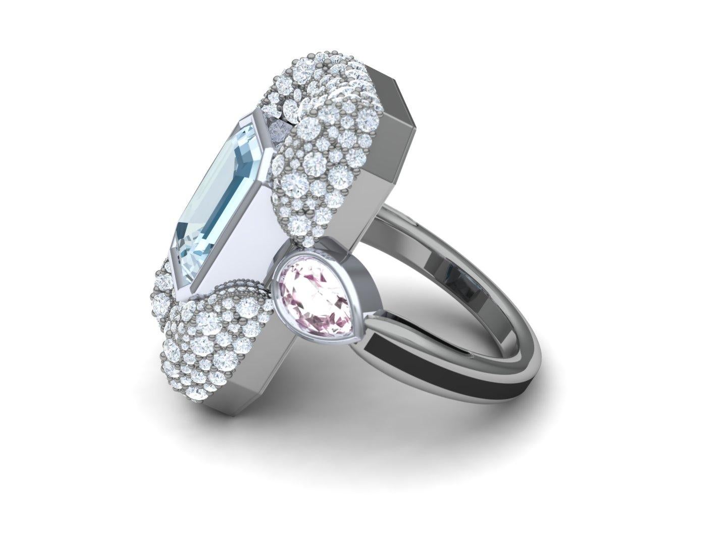 A pastel play on a modern ring.  These soft colors of pink blue and white play wonderfully together among a cold blue grey background.  The center stone is a emerald cut aquamarine that weighs nearly 4 carats.  The stone has a steel blue appearance