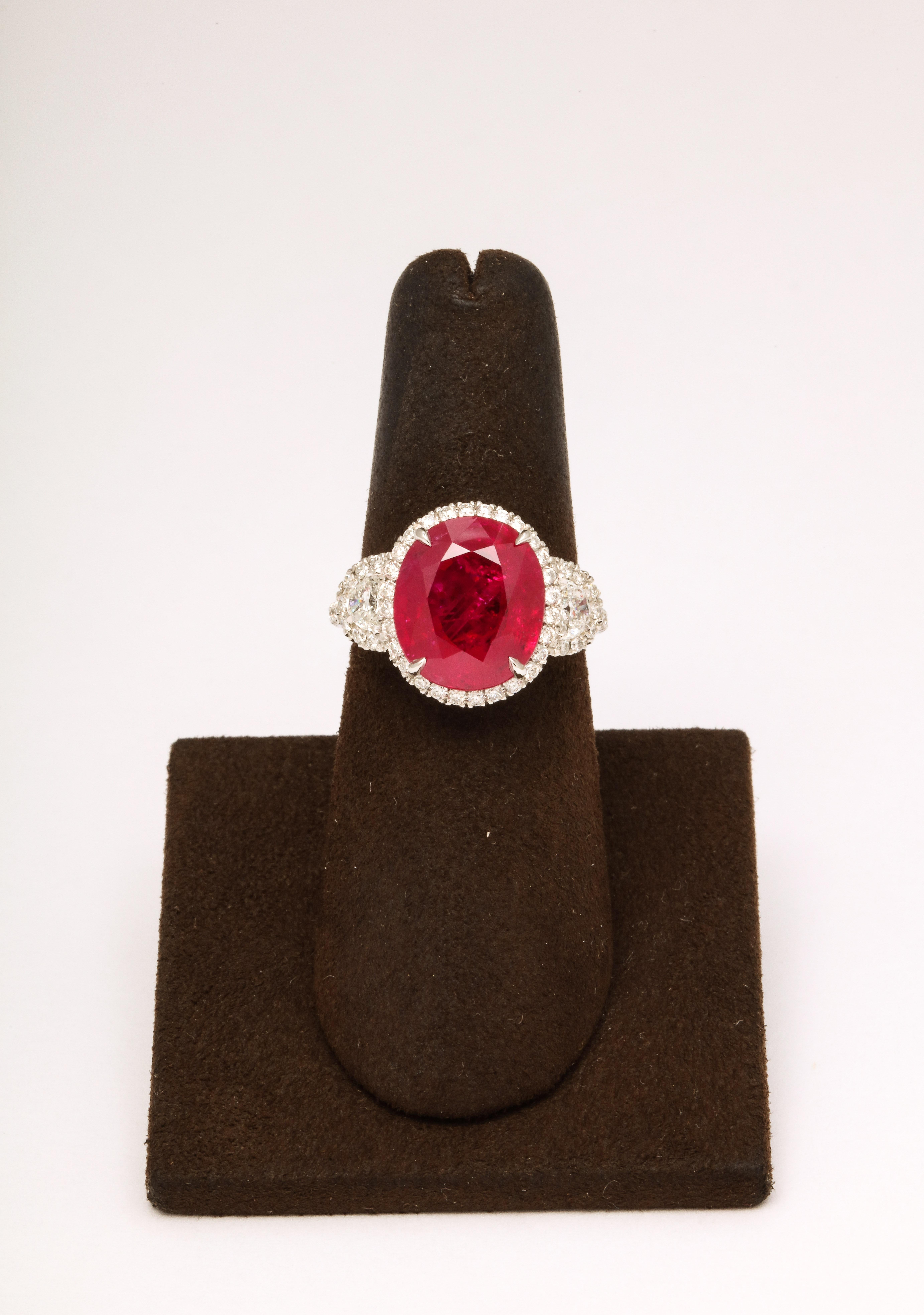 
7.18 carat Certified Burma Ruby 

Set in a custom platinum and diamond mounting featuring 1.01 carats of white round and half moon cut diamonds. 

A fabulous ring with exceptional color. 

Currently a size 6, this ring can easily be sized to any