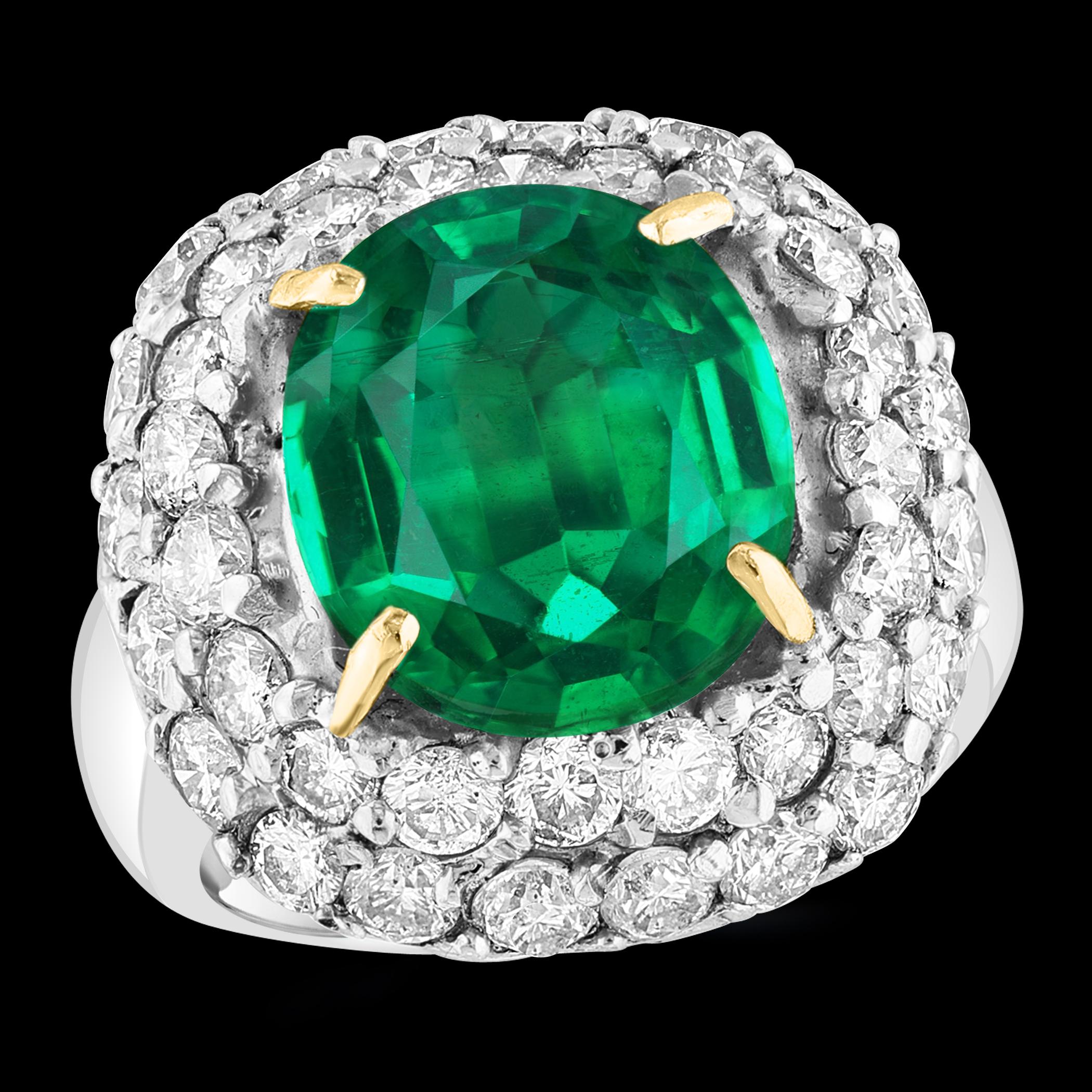 This stunning ring features a 7 Carat Cushion Cut Colombian Emerald set alongside 3.5 Carats of brilliant round diamonds in a platinum setting. The emerald is  absolutely gorgeous, highly desirable in color, and of extremely fine quality, boasting
