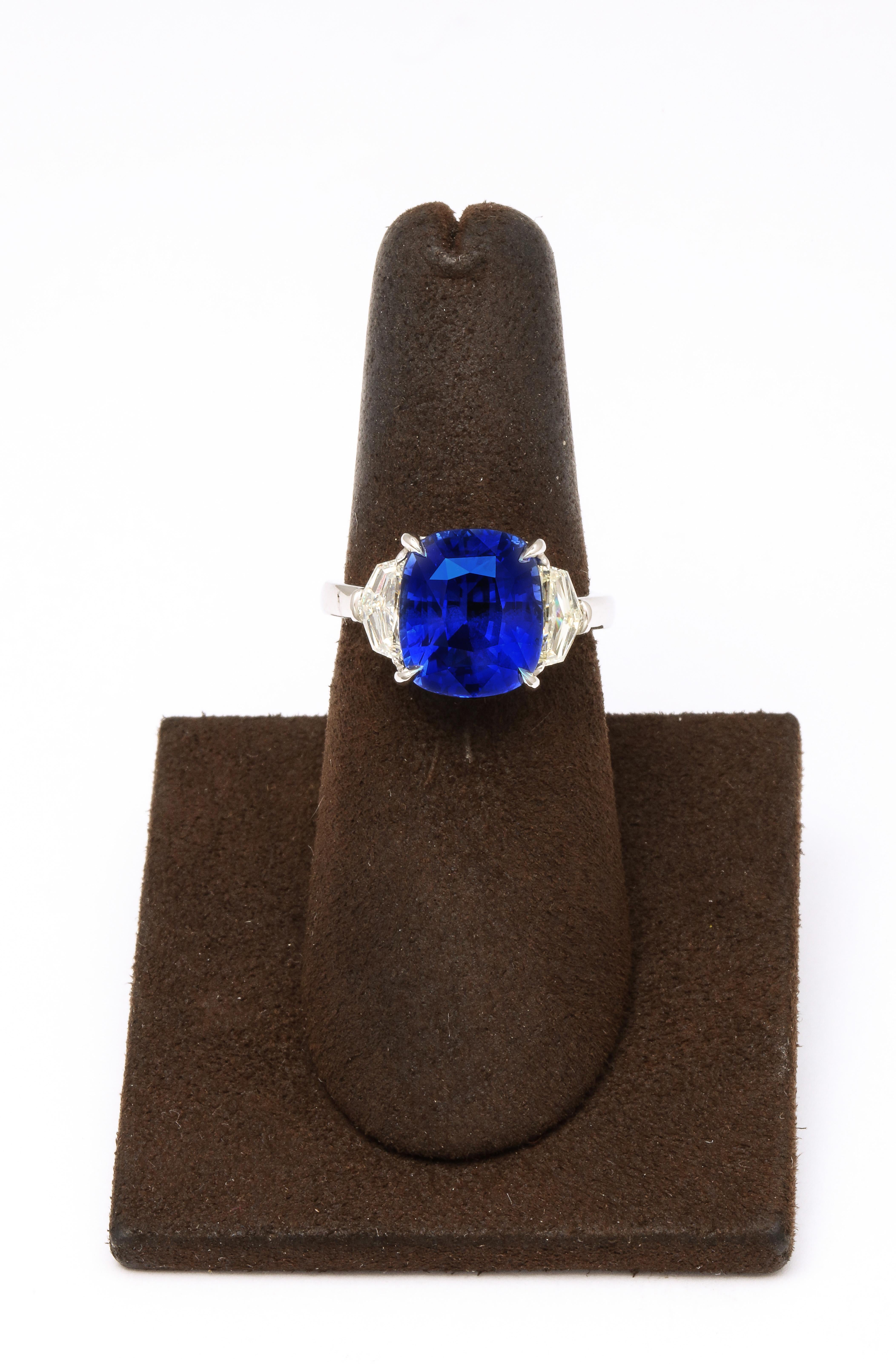 
Certified 7.16 carat Cushion cut Ceylon Blue Sapphire. 

.73 carats of white epaulet side diamonds. 

Custom platinum mounting 

Certified by Christian Dunaigre of Switzerland

Currently a size 6.25, this ring can be sized to any finger size. 