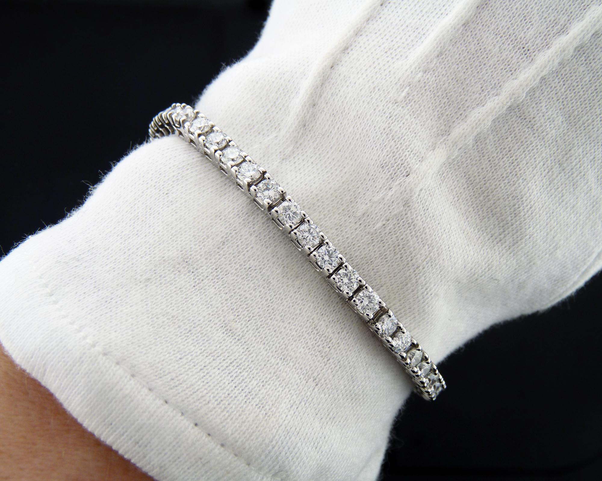 A classy tennis bracelet set with 46 round diamonds weighing a total of 6.9 carats (0.15ct each).
Diamonds are estimated as G-H color, VS-SI clarity.
4-prong setting in 14k white gold.
Gross weight: 17.42 gram.
Length: 7.13 inches.
Width:  0.47