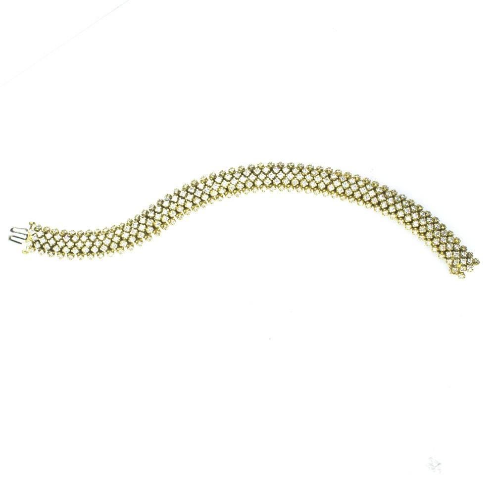This 7-Carat Diamond Bracelet features five rows of 260 round brilliant cut diamonds. The diamonds are graded H-I color and SI clarity. Beautifully crafted, the bracelet is fashioned in 18 karat yellow gold. 