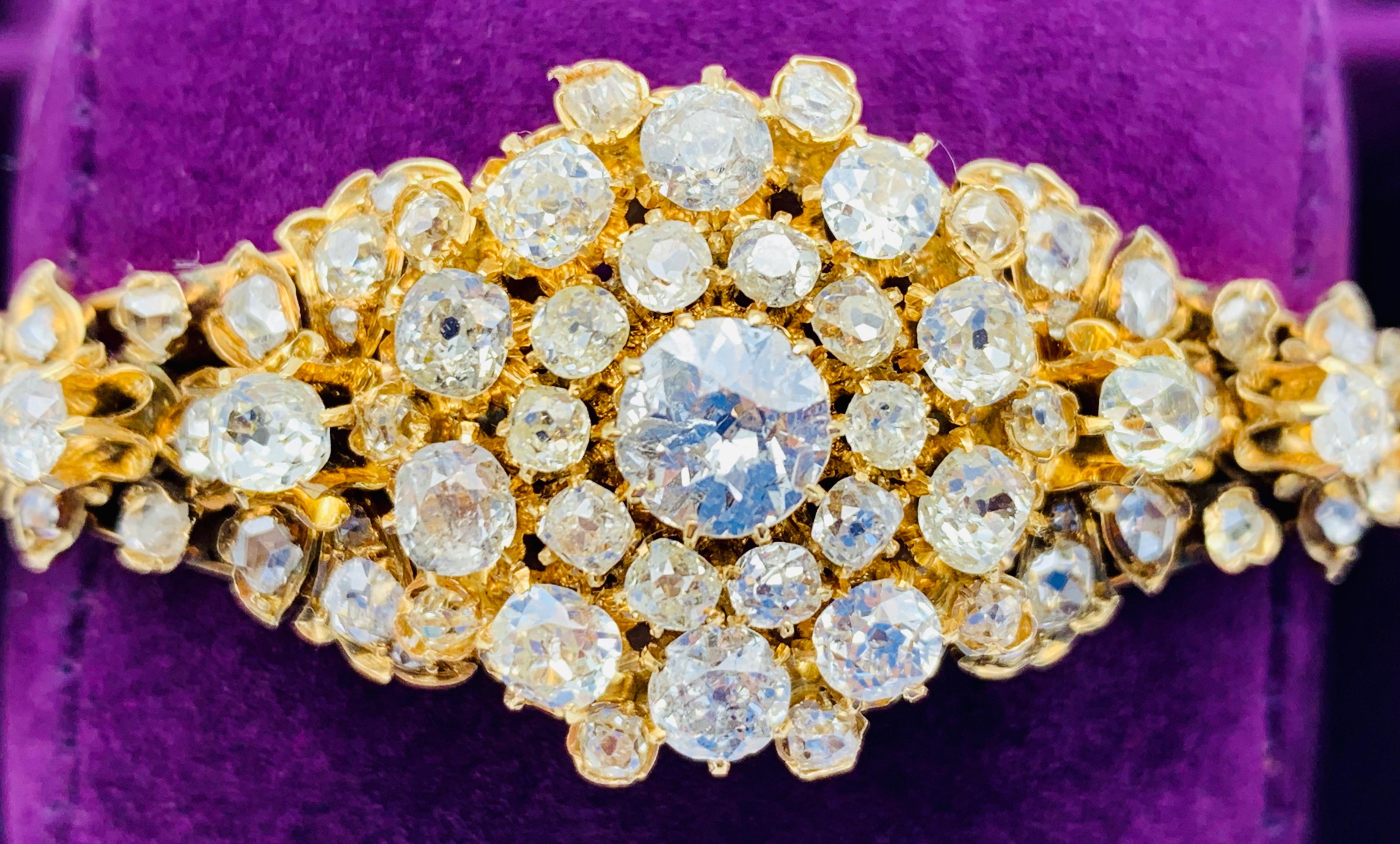 The center of this stunning bracelet is a diamond rosette consisting of one larger central diamond surrounded by 30 diamonds of different size. Two butterflies and calyxes of flowers made out of a further 50 diamonds decorate the shoulders of the