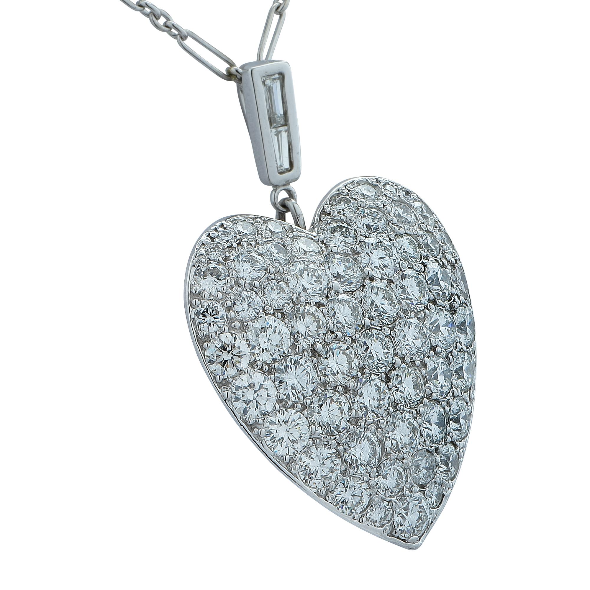 Breathtaking heart pendant and necklace, custom made in platinum, featuring 68 round brilliant cut diamonds and 2 baguettes, weighing approximately 7 carats total, G color, VS clarity. The heart measures 1.12 inches in length and 1 inch in width.
