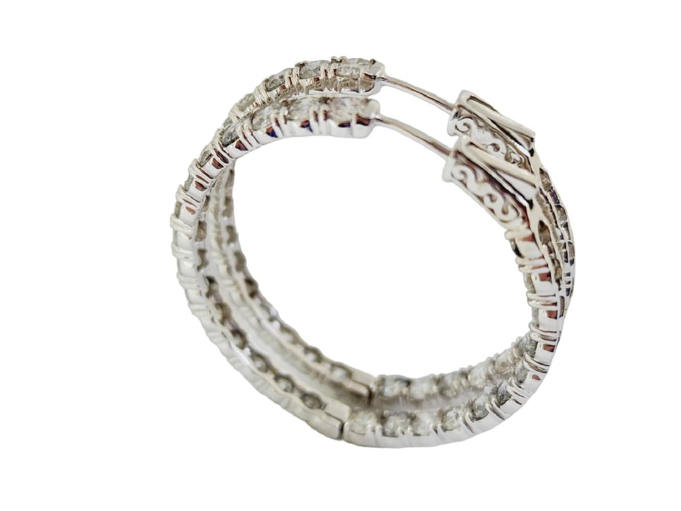 Beautiful pair of natural diamond inside out hoop earrings in 14K white gold. Secures with snap closure for wear. Average Color H, Clarity I, Measures 1 inch x 1 inch diameter. 