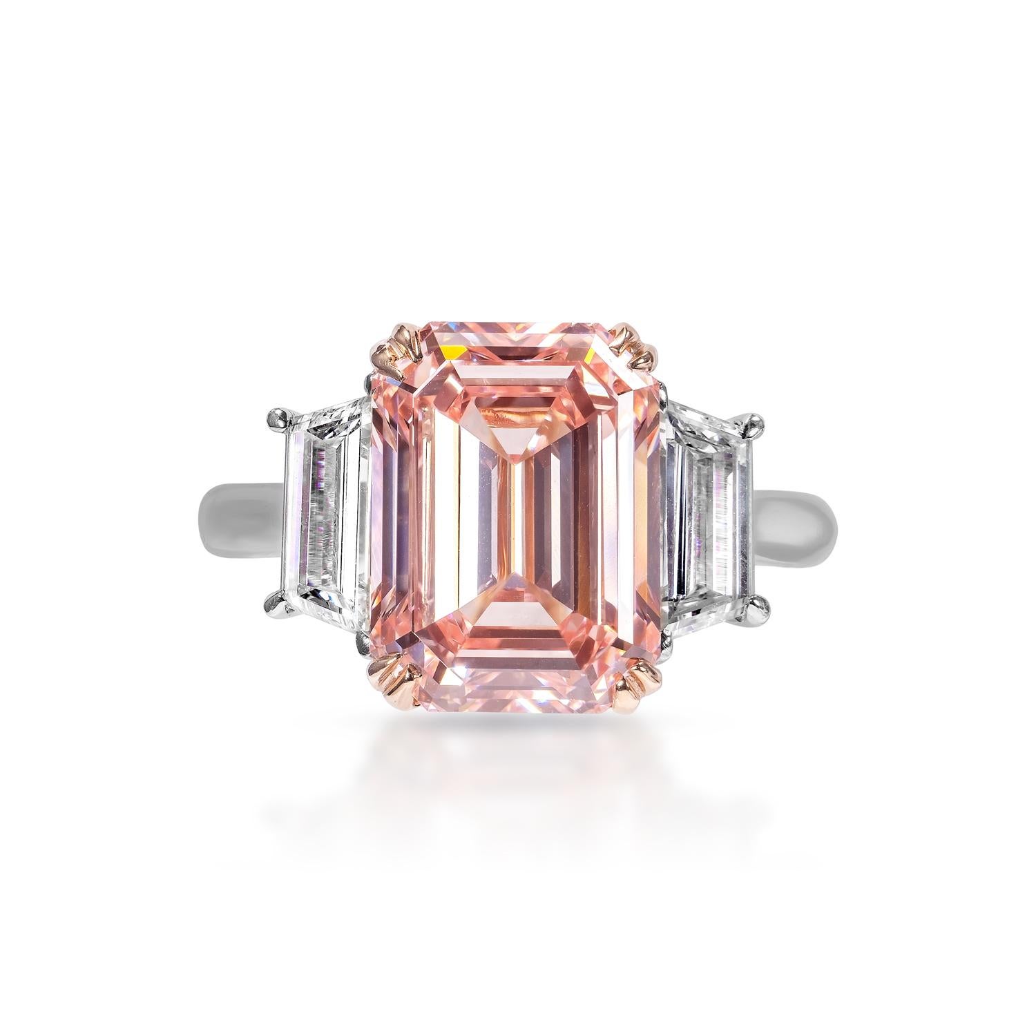 GIA Certified

Earth Mined Center Diamond:
Carat Weight: 5.50 Carats
Color: fancy vivid pink *
Clarity: VVS2
Style: Emerald Cut
*This Diamond has been treated by one or more processes to change its color

Carat Weight: 1.17 Carats
Shape: Trapezoid 
