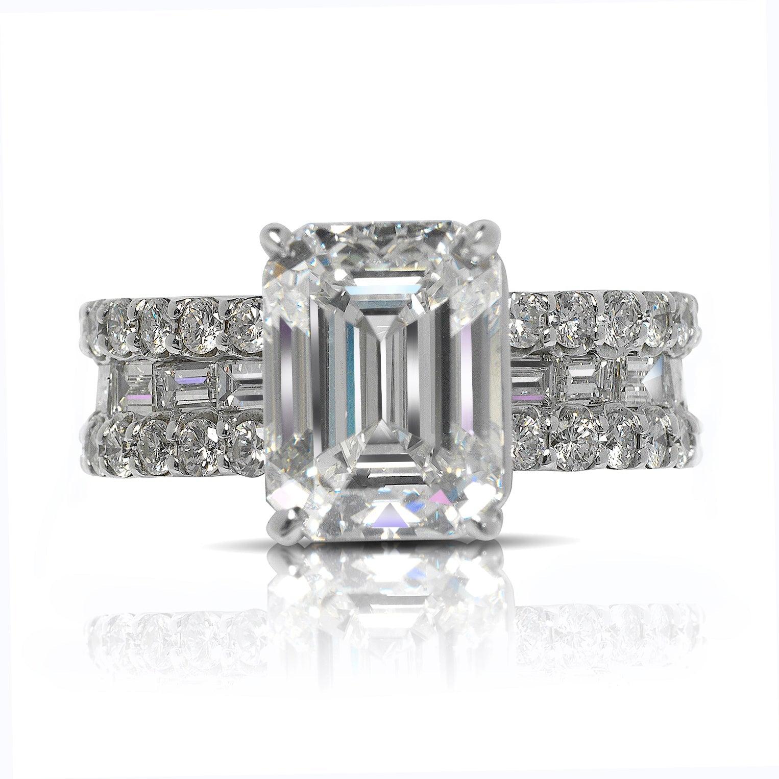 TORA EMERALD CUT DIAMOND ENGAGEMENT RING BAGUETTE CHANNEL SET ETERNITY BAND IN 14K WHITE GOLD  

Center Diamond
Carat Weight: 4.4 Carats
Color :   H*
Clarity:  VVS1
Cut: EMERALD CUT
Measurements: 10.5 x 7.9 x 5.5 mm
* This diamond has been treated