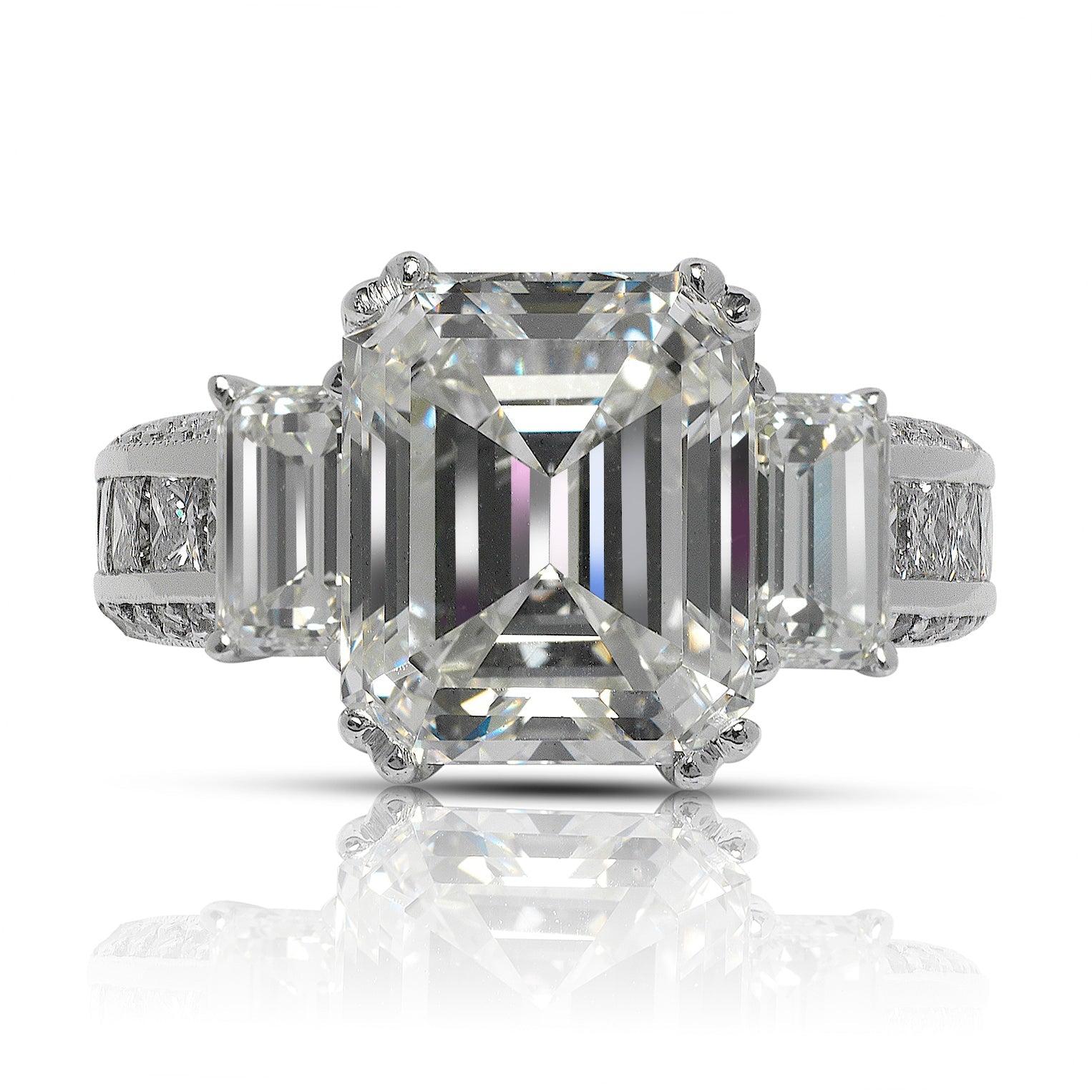 NINA EMERALD CUT THREE STONE BAGUETTE DIAMOND RING WITH CHANEL SET BAND IN  18K WHITE GOLD

GIA CERTIFIED 
Center Diamond
Carat Weight: 5.1 Carats
Color :   J
Clarity:  VVS2
Cut: EMERALD CUT
Measurements: 10.6 x 9.9 x 6.0 mm

Ring:
Metal: 18K WHITE