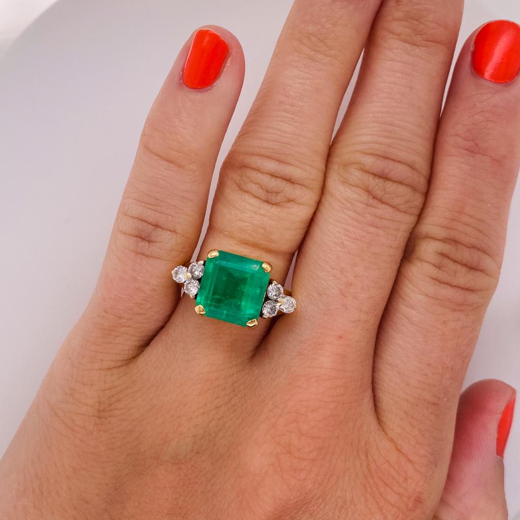 Celebrate a May loved one with this emerald and diamond ring, or an April-May pair! This ring is a perfect creation built to be worn while appearing lightweight. The thoughtfully designed ring presents the gemstones as the focus but underneath the