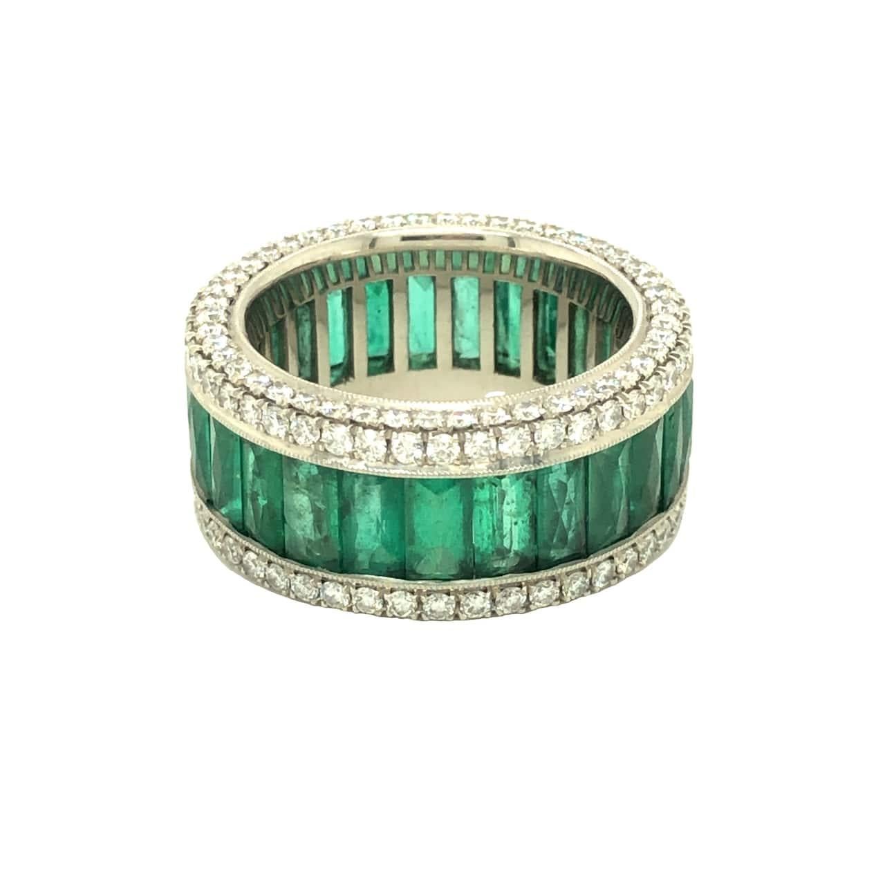 Beautiful fine detail and craftsmanship surely makes this ring special. Matching French cut emeralds are set in channel setting with fine milgrain and framed with colorless diamonds. On either sides of the band, small diamonds continue to add