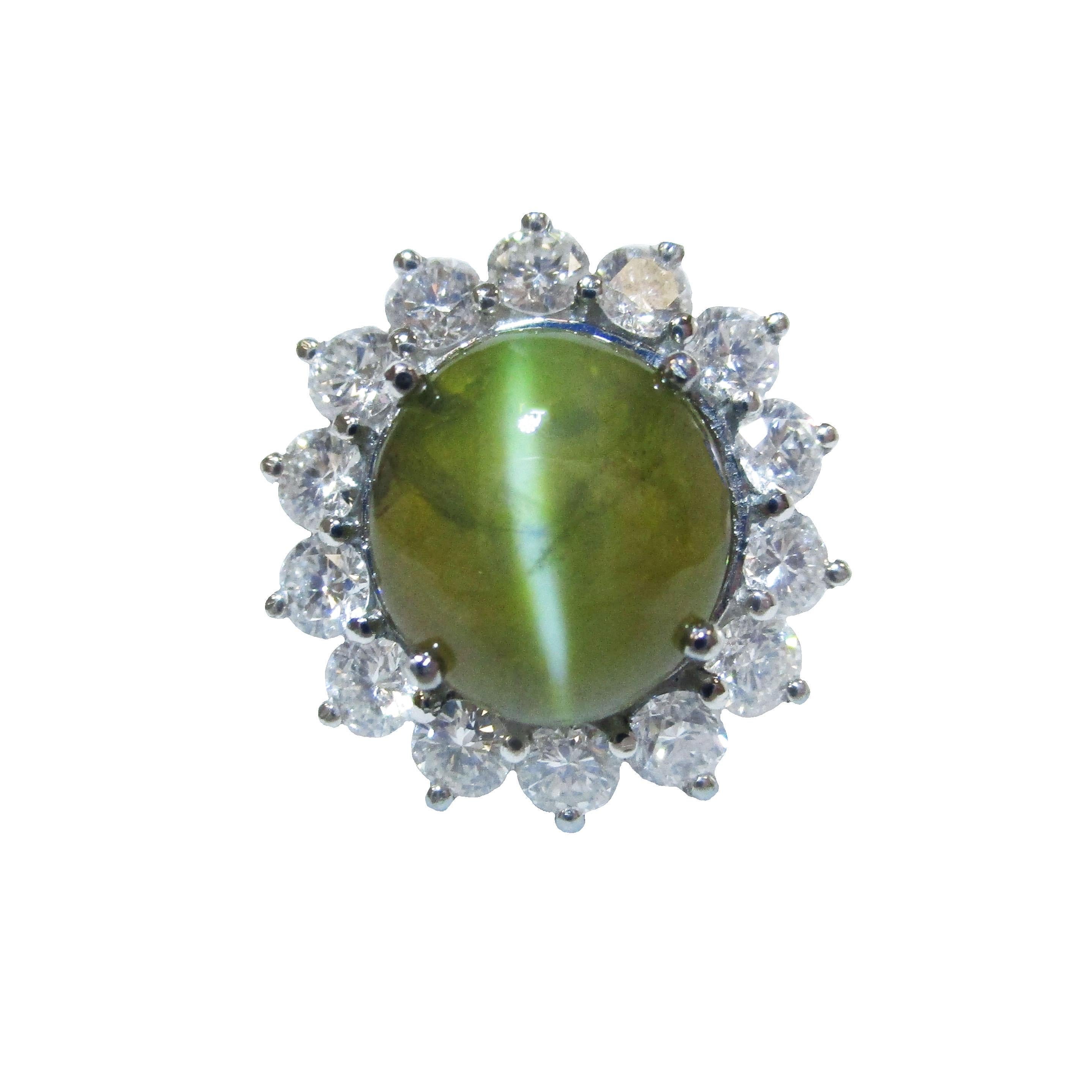 This gorgeous platinum ring features a stunning 7+ carat cat's eye chrysoberyl that carries a GIA report and is surrounded by brilliant white diamonds. The cat's eye chrysoberyl has rich brown honey colored undertones that seems to glow in the