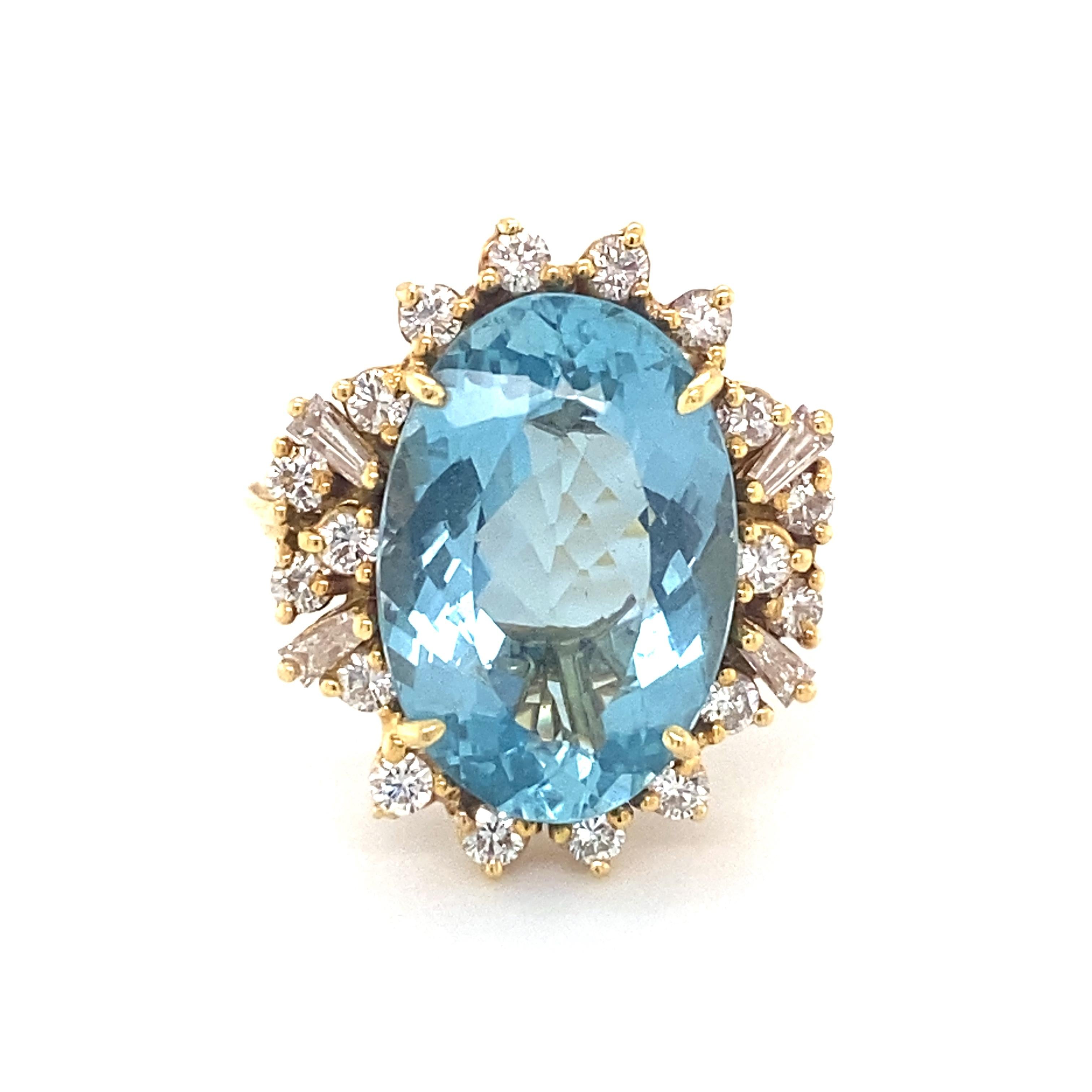 1970s 7.0 Carat Oval Aquamarine with Diamond Halo and 18 Karat Yellow Gold Ring. The Oval Cut Brilliant Aquamarine has a clear Blue color. It is surrounded by a .5 carat total weight Halo of Round Brilliant and Baguette Diamonds. This stunning ring