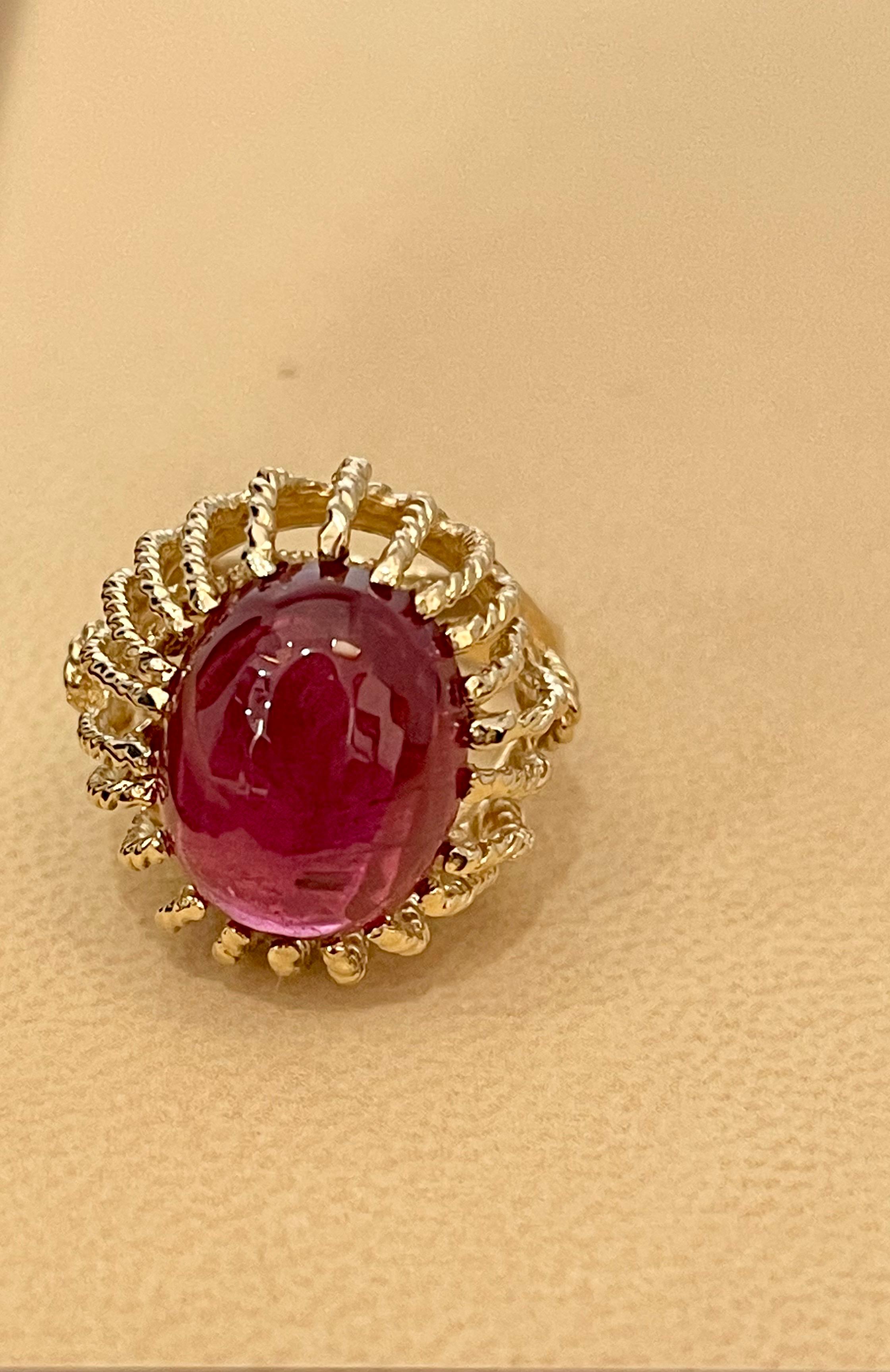 Approximately 7 Carat Oval Cut  Cabochon Pink Tourmaline 14 Karat Yellow Gold Ring Size 7
7 Carat of Pink Tourmaline oval shape  surrounded by nice gold design.
Gold: 14 Karat Yellow  gold , Beautiful design
Weight: 12 gram Including stone

Ring