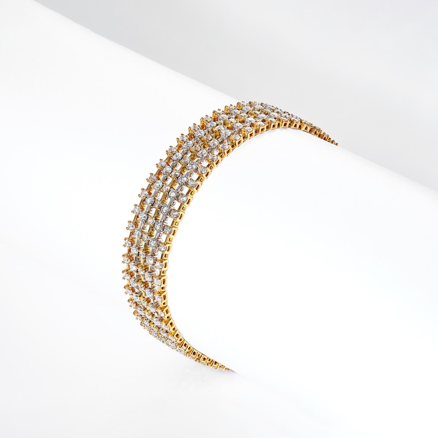 This Jazmin 7 Carat 5 Strand Diamond Bracelet is a breathtaking piece of jewelry, crafted with luxurious 18K yellow gold and intricate diamond detailing. Featuring a total of 250 diamonds, this bracelet truly stands out in a crowd. Stunning and