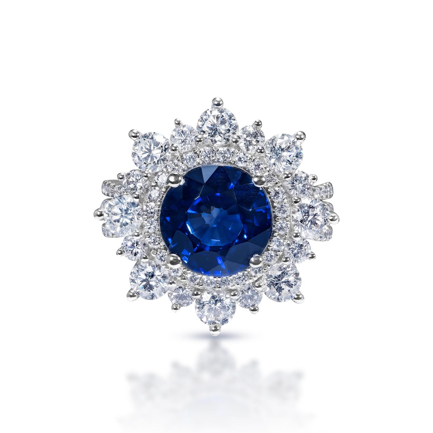 Center Stone Sapphire Ring:
Carat Weight: 4.72 Carats
Color: Blue Sapphire - Diffused J’adore Sapphire
Style: Round Brilliant Cut

Diamond:
Carat Weight: 2.49 Carats
Shape: Round Brilliant Cut
Settings: 4 round prong & micro pave
Metal: 18 Karat