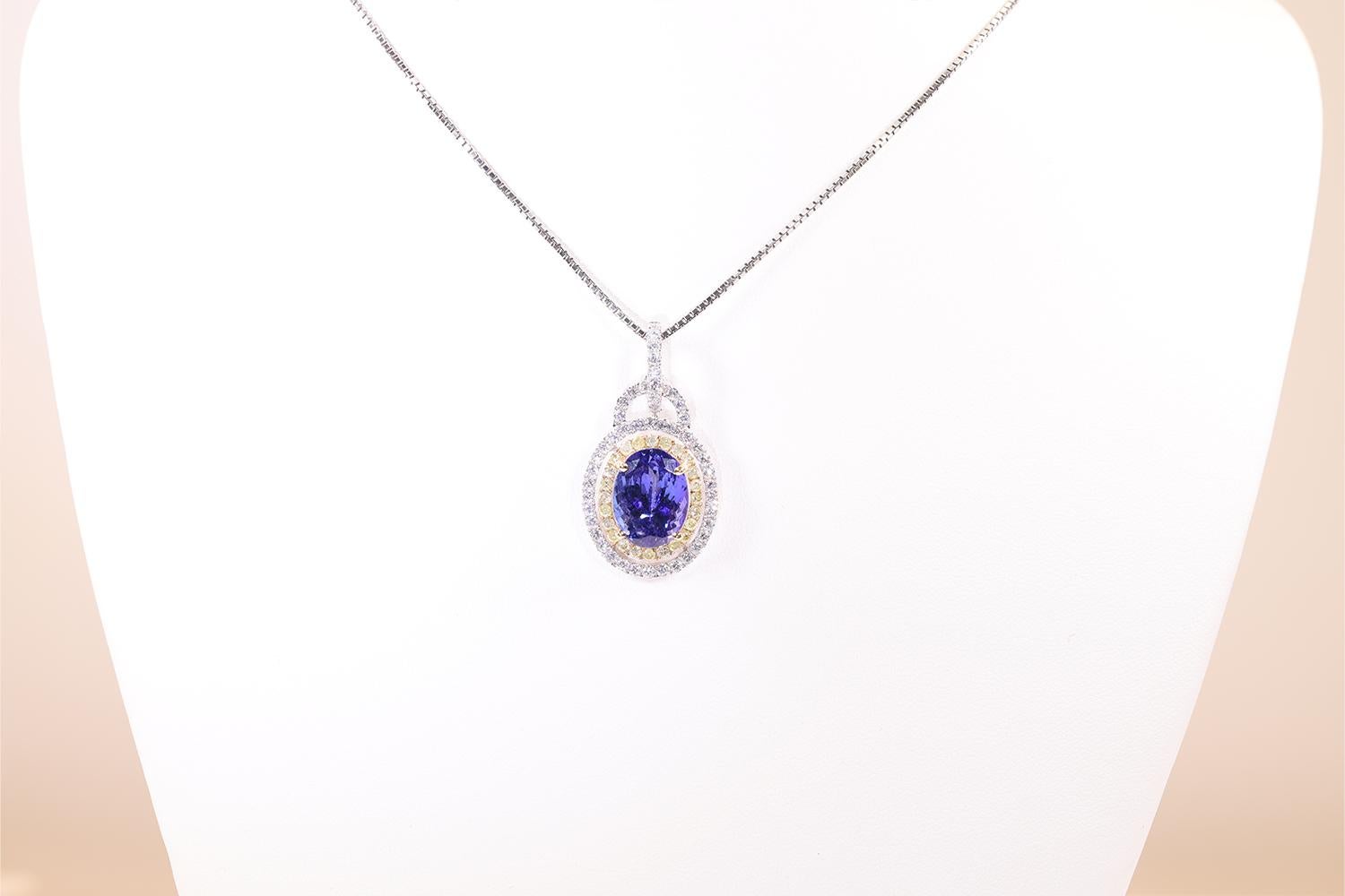 This Double Halo necklace features a Heskia Almor Design Inc. mounting with yellow and white diamonds. The center stone is a 7.17 carat AAA Tanzanite stone and the whites diamonds weigh 1.06 carats and the yellow diamonds weigh 0.57 carats creating