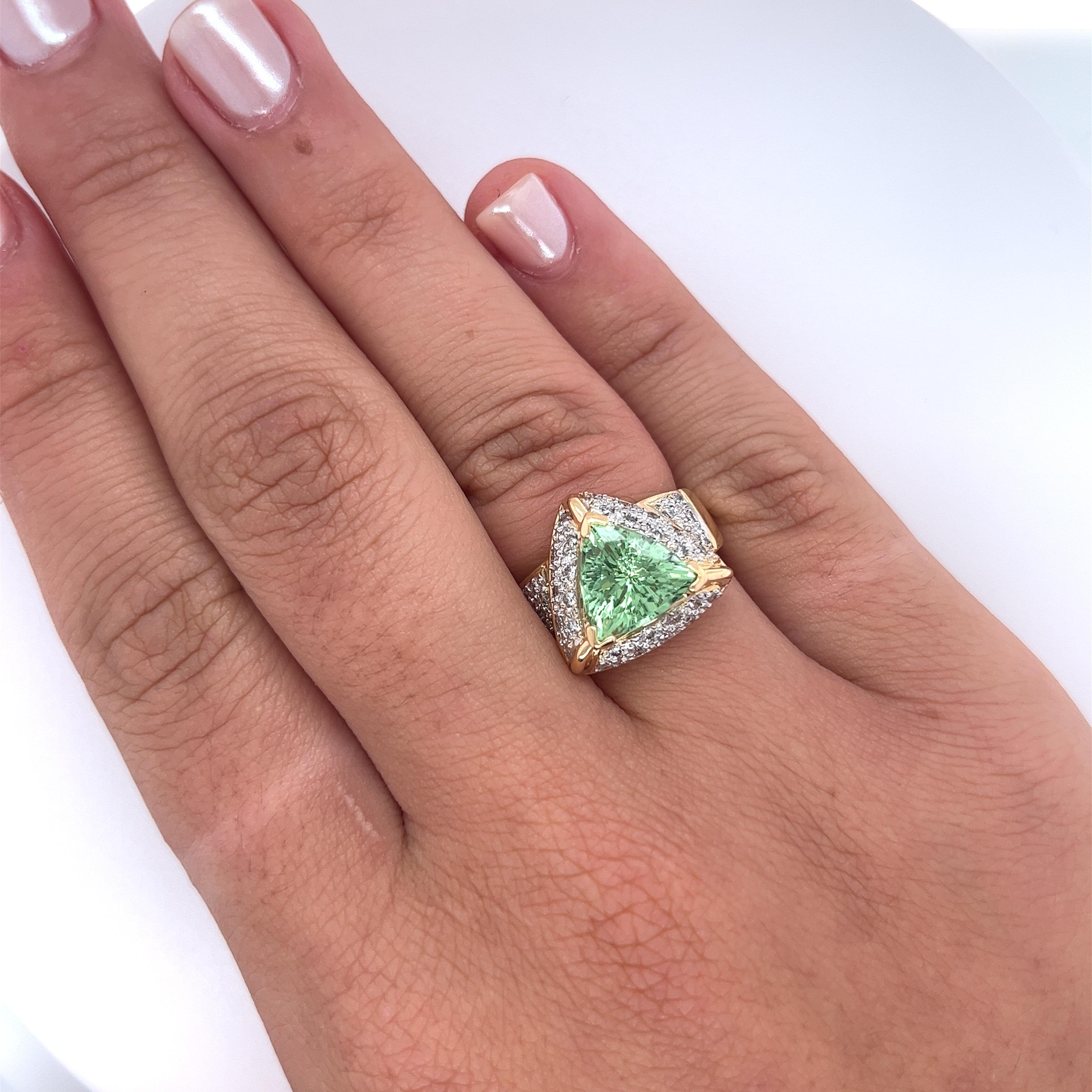 Trilliant Cut Green Watermelon Tourmaline and Round Diamond Side Stone Ring, a resplendent statement in 18K White and Yellow Gold. Weighing 11.3 grams, this semi-precious ring boasts a magnificent 7-carat trilliant-cut green watermelon tourmaline,