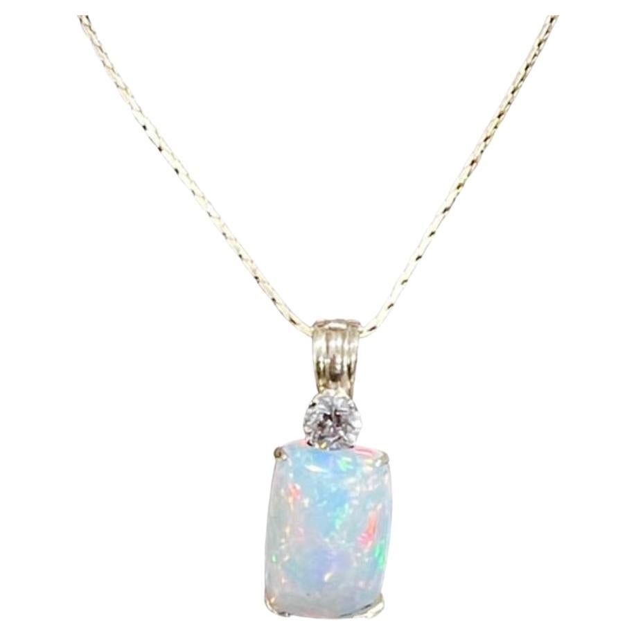Approximately 7 Carat  Ethiopian Opal & Diamond Pendant / Necklace 14 Karat + 14 Kt Gold Chain
This spectacular Pendant Necklace consisting of a single  Ethiopian Opal Approximately  7 Carat. 
17 X 11  mm Cushion shape 
very clean Stone no inclusion