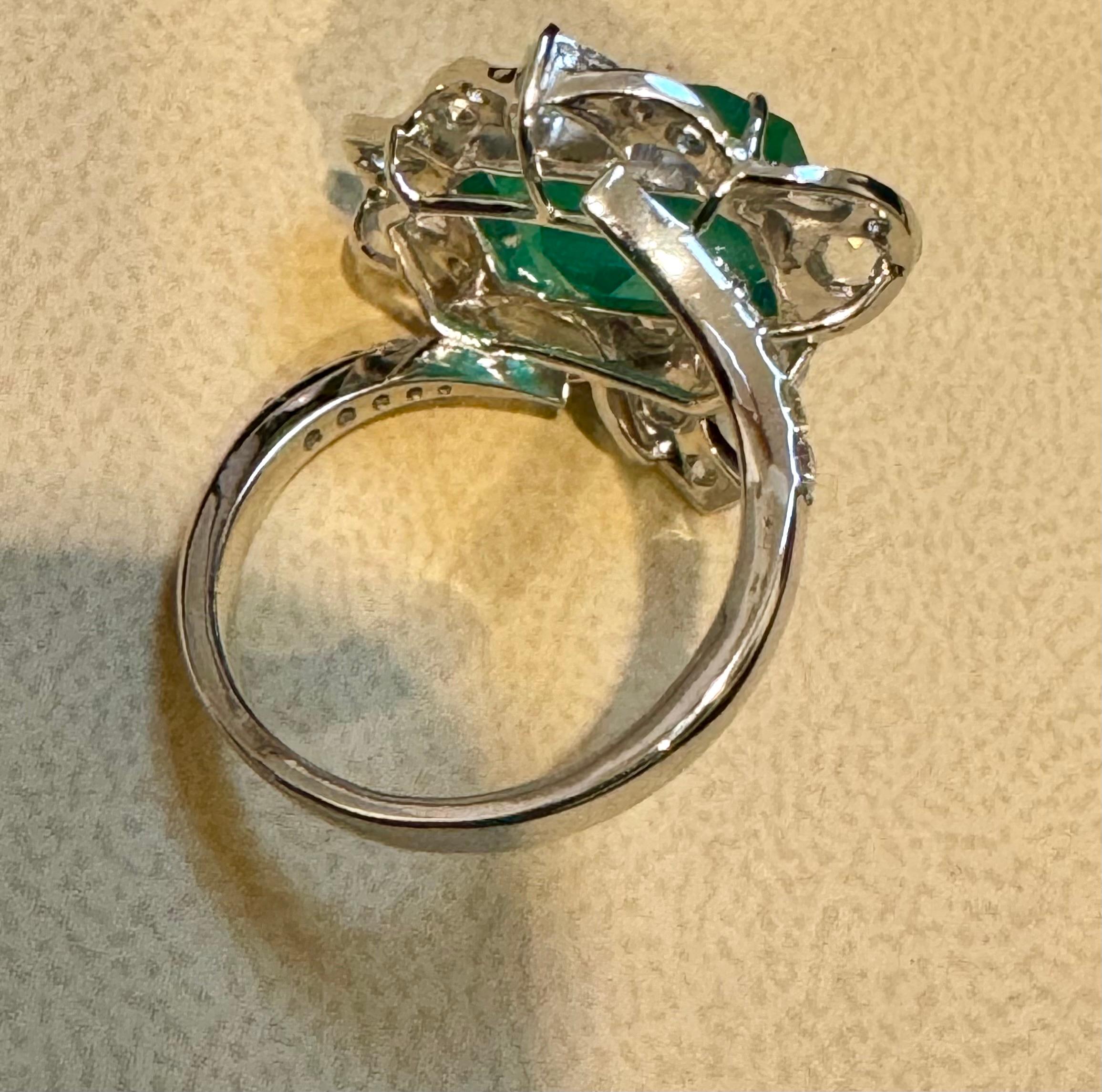7 Ct Finest Zambian Emerald Cut Emerald & 1.5Ct Diamond Ring, 18 Kt Gold Size 9
 This classic ring features an Emerald cut Zambian emerald of extreme fine quality, boasting a desirable color and luster, originating from Zambia. Accompanied by many 