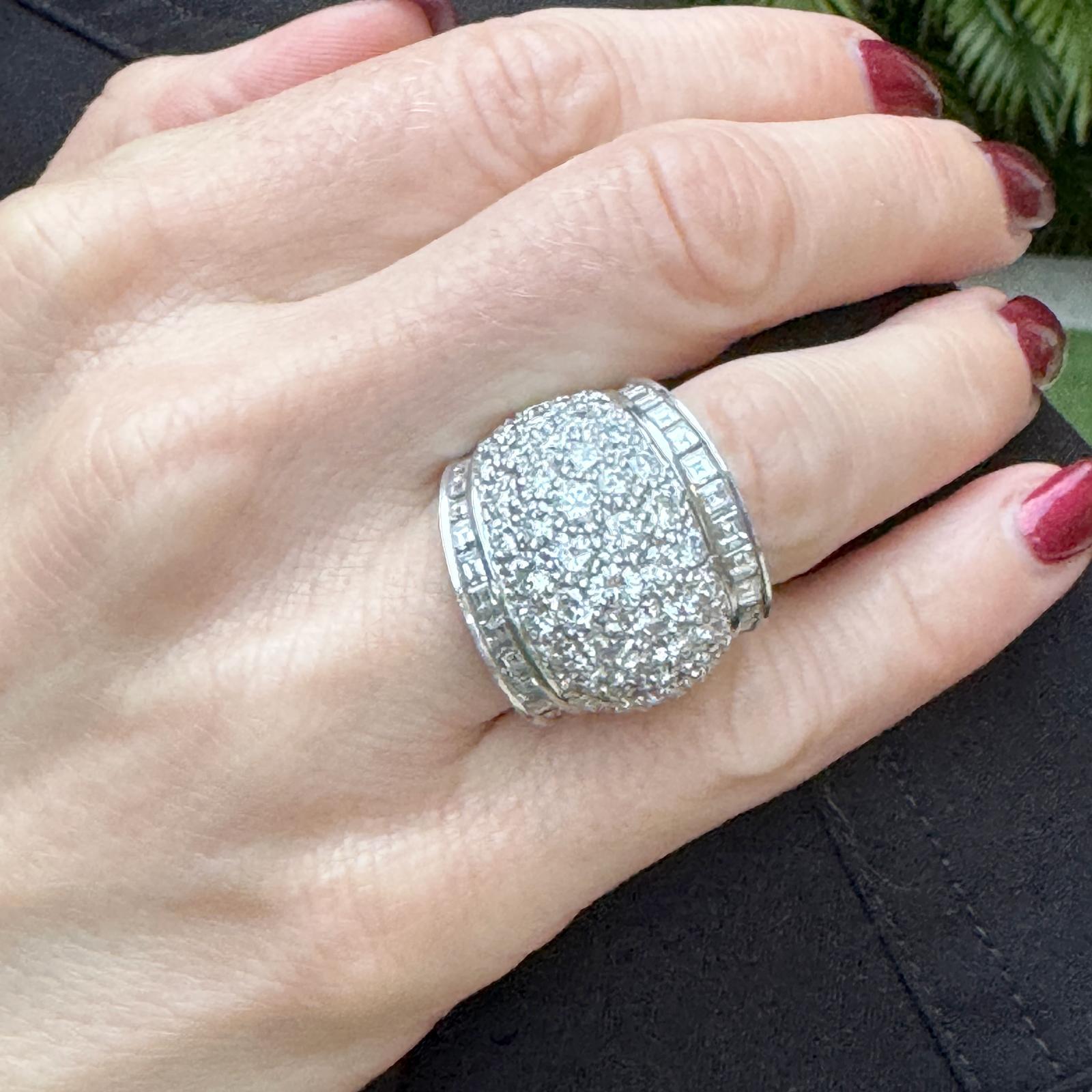 This stunning platinum pave diamond dome eternity band ring features a striking design with a mix of round brilliant cut and baguette diamonds, totaling approximately 7.00 carats. The diamonds are graded G-H for near-colorless brilliance and range