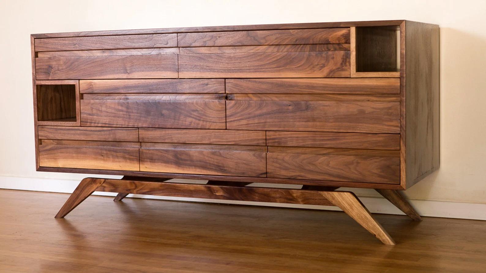 This dresser is an original design, inspired by the modern, minimal, clean aesthetic of midcentury/ Danish modern. It has seven drawers that glide on soft-close hardware for the utmost in smooth operation, and the two cubbie openings are there to be