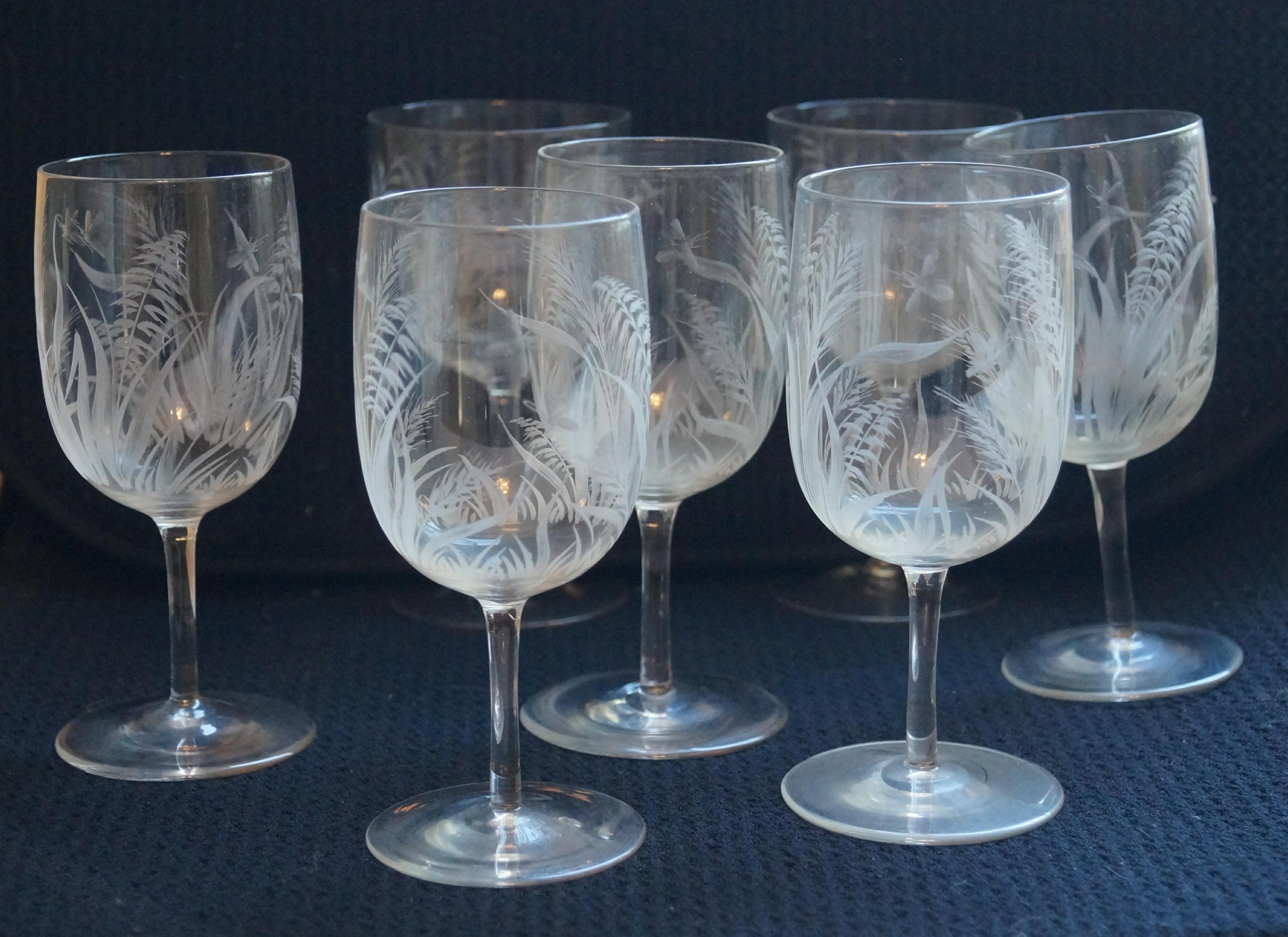 These are believed to be by Boston & Sandwich spool stem goblets, blown between 1870 & 1887, which were individually hand engraved by Cape Cod glass men descended from the highly skilled German engravers that old Deming Jarves imported to work in
