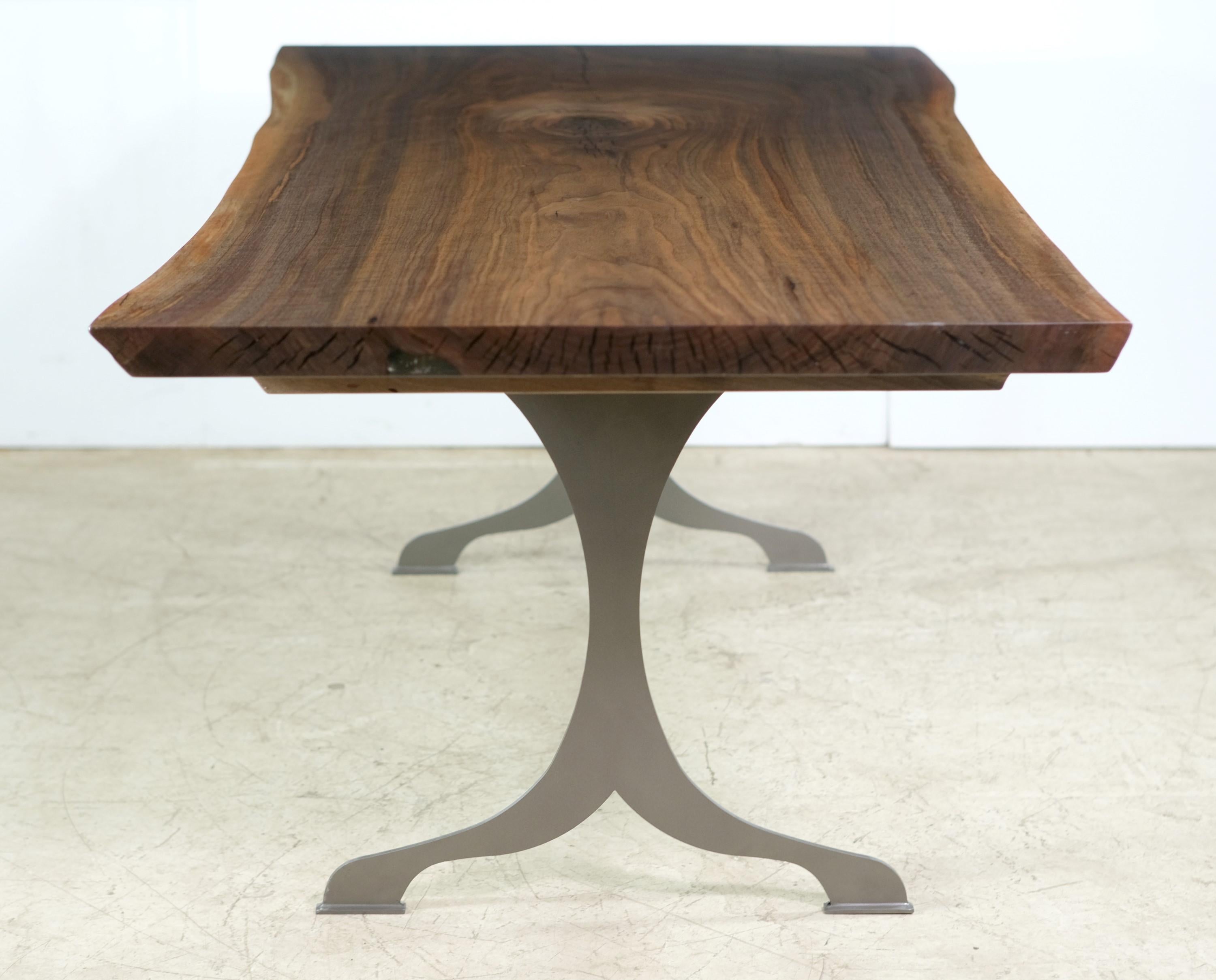 This table features a live edge solid walnut top paired with custom made brushed steel wishbone legs. This table is ready to ship. Please note, this item is located in our Scranton, PA location.