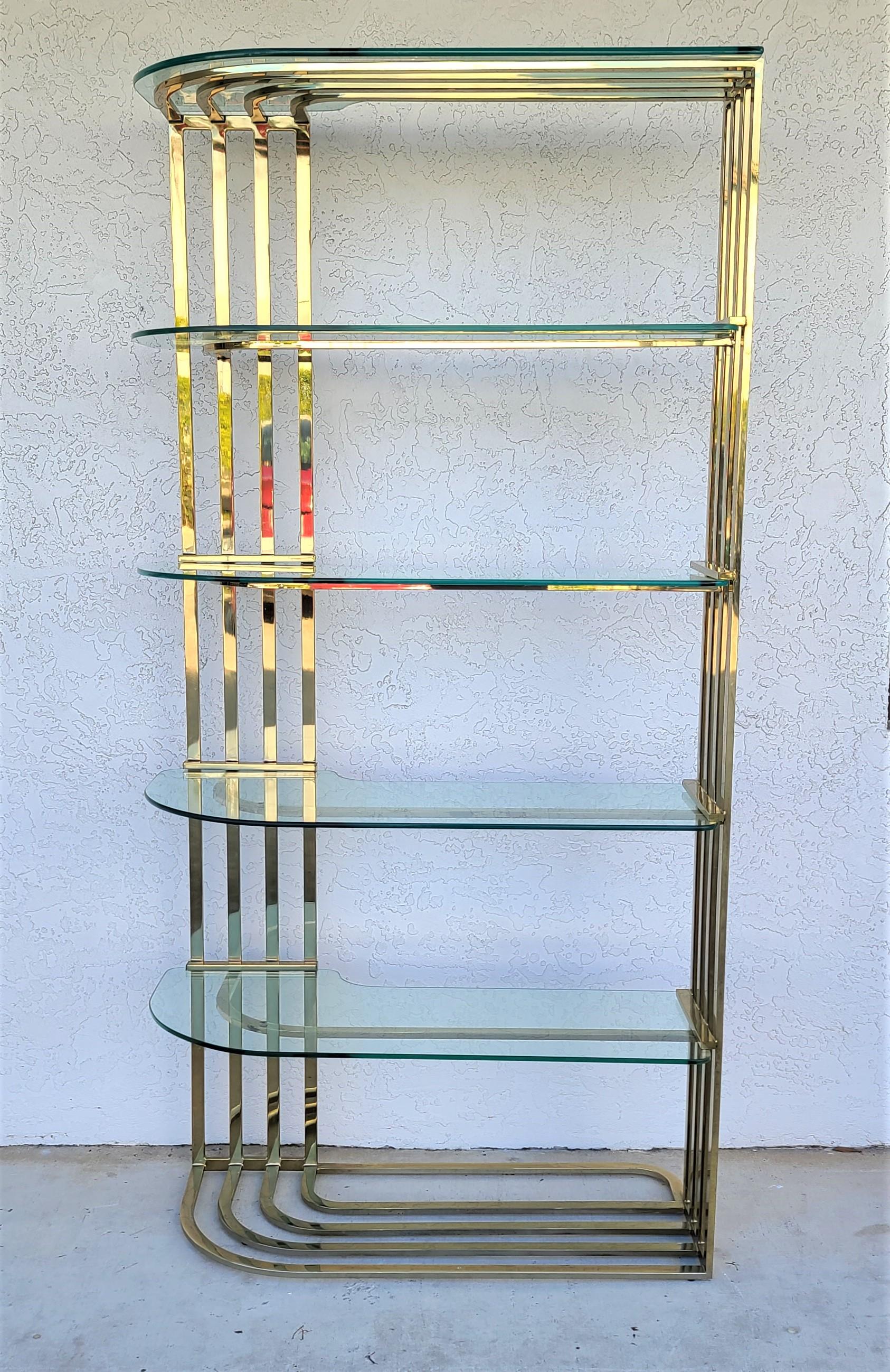 Offering One Of Our Recent Palm Beach Estate Fine Furniture Acquisitions Of A
Vintage Sculptural Brass Plate and Glass Étagère Bookcase
Custom cut glass shelves fit into grooves on both ends.
The glass shelf currently on the top shelf in the