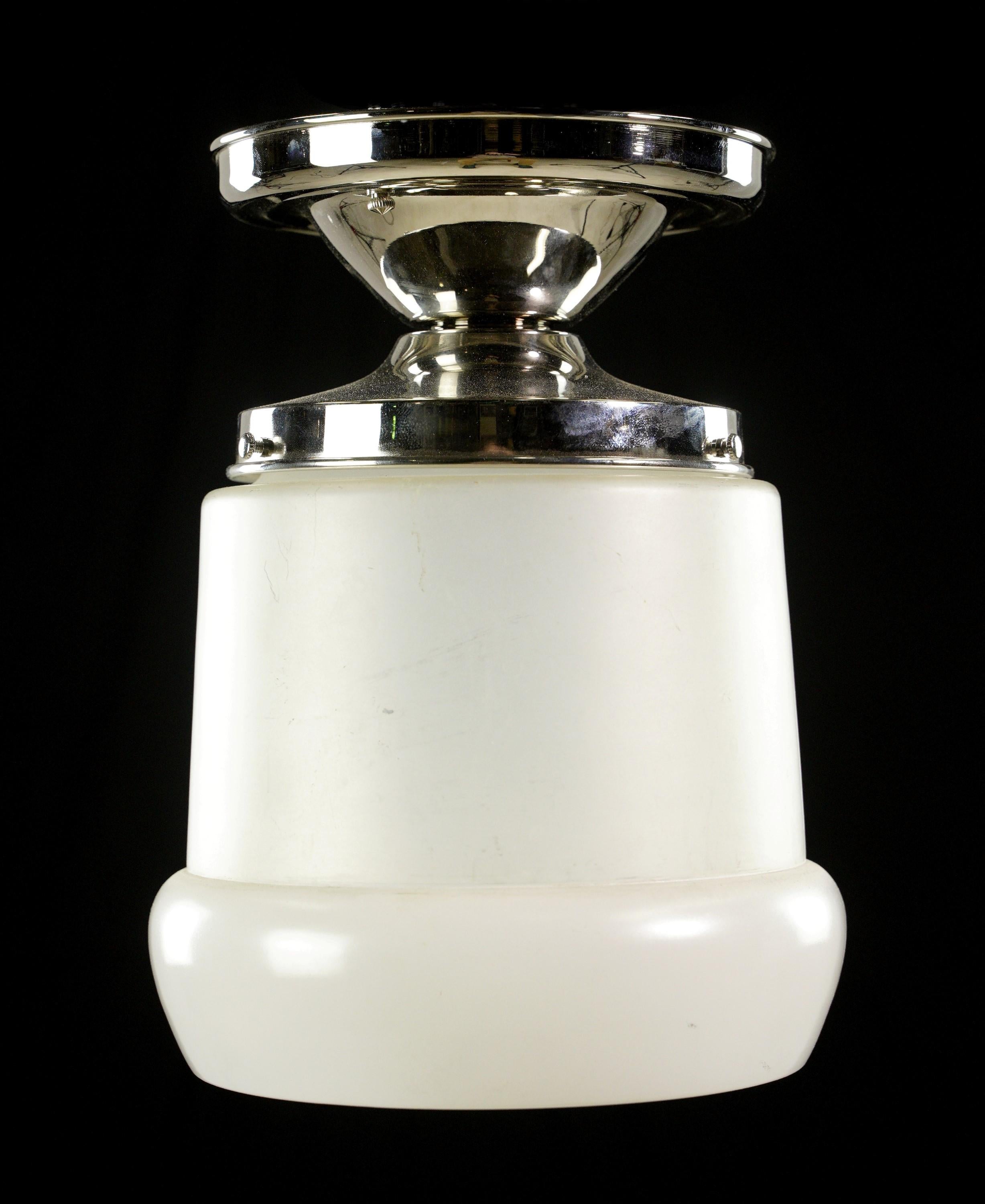 This Streamlined style white frosted glass & steel semi flush mount light exudes a soft and elegant glow. The white frosted glass shade adds a touch of sophistication, while the steel frame provides durability. This semi flush mount light is a