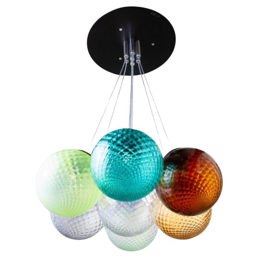 7 lights ceiling chandelier with colored transparent Murano glass spheres For Sale