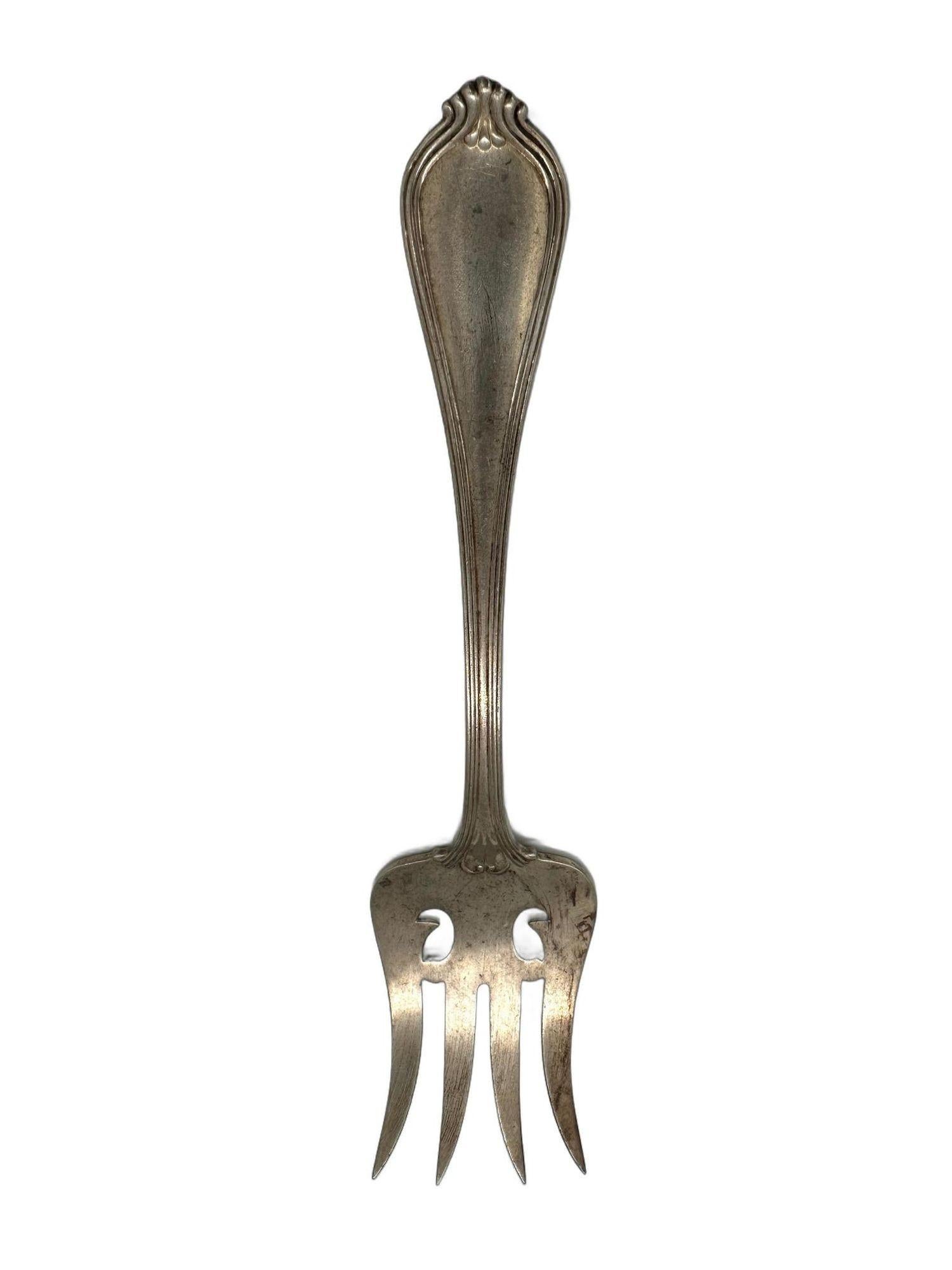 Elevate your dining experience with this exquisite Paul Revere pattern Cold Meat Fork by Towle Sterling Silver.. This 7-inch sterling silver fork combines timeless design with intricate piercing for a touch of sophistication. It's the perfect