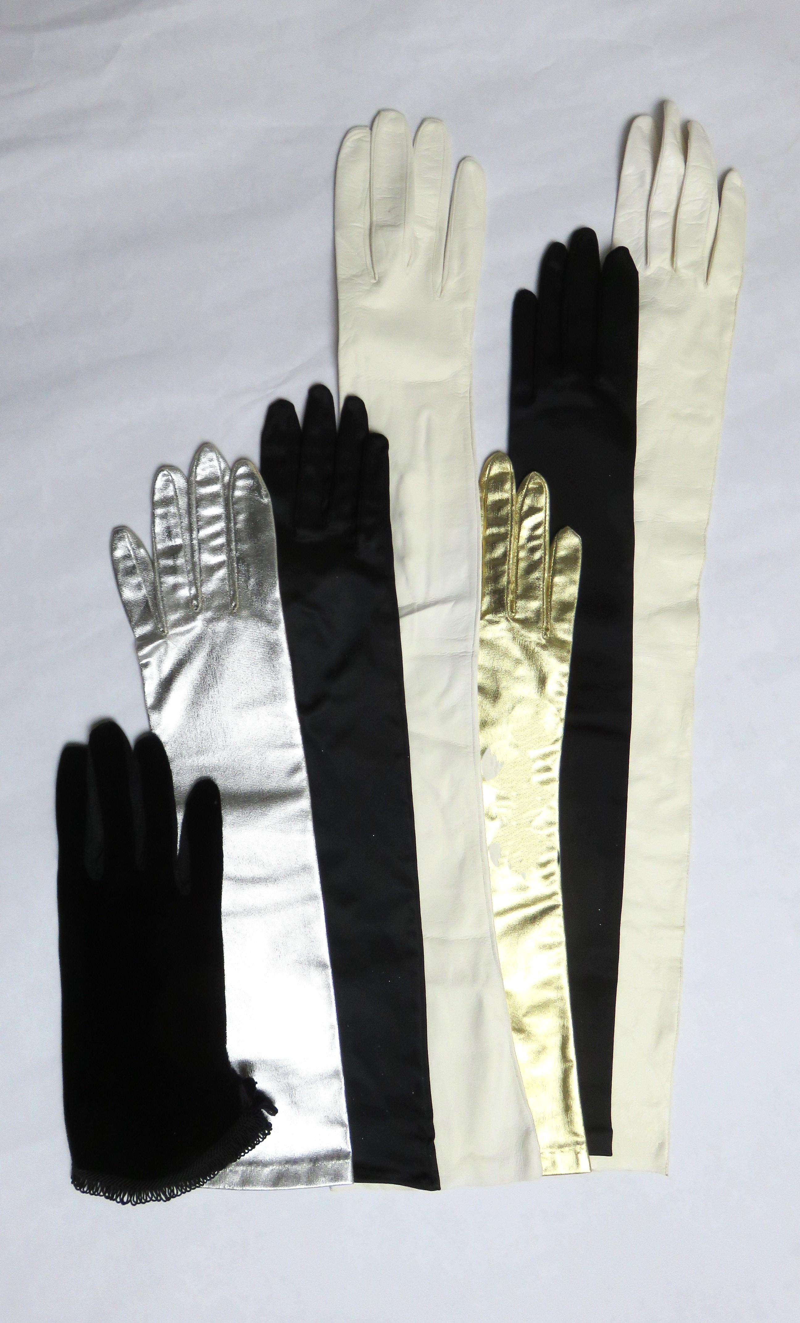 Seven pairs of gloves in different fabrics and lengths from the 1960s and 1970s. A pair of Christian Dior black stretch satin above elbow length size 7 come with their Dior holder and sleeve. There are 2 pair of white opera length, one in doeskin