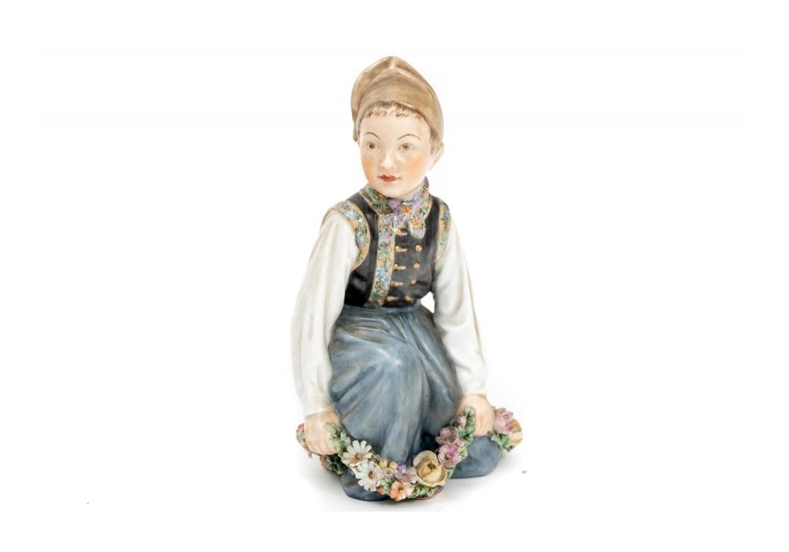 Included in this fine group:
Amager Boy in typical costume designed by Carl Martin-Hansen circa 1906 - 1925. From the Danish National Costume series by Carl Martin-Hansen. Figurine depicts a little Amager boy kneeling with a garland of flowers at