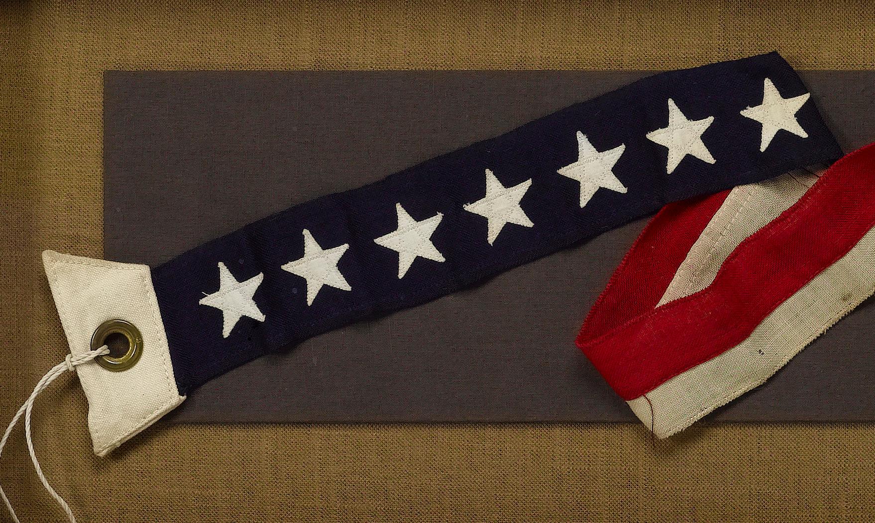 This is a 7-Star Naval Commissioning Pennant, circa 1892-WWI. A naval commissioning pennant is flown at all times as long as a ship is in commissioned status, except when a flag officer or civilian official is embarked and flies his personal flag in