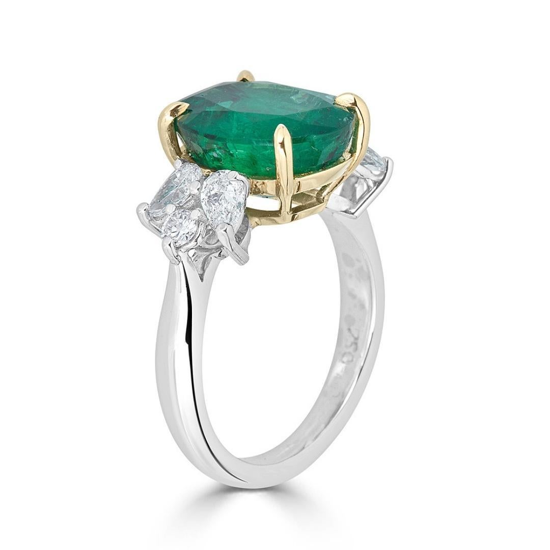 This splendid, timeless, and classic ring can easily become a family heirloom considering its quality design will stand the test of time. The perfect 5.28 carat round emerald is set in 18k yellow gold 4-prongs and basket, the 4-pear shaped and 2