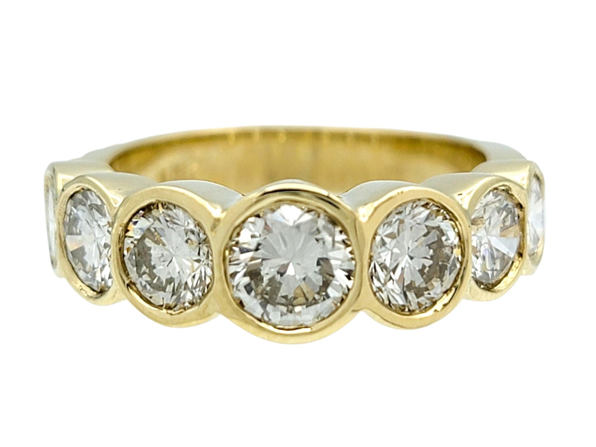 Ring Size: 4.5

This brilliant band-style diamond ring makes a bold and elegant impression with its lineup of seven round-cut diamonds set in individual bezels. Each diamond sits flush in a high polish 14 karat yellow gold setting, creating a
