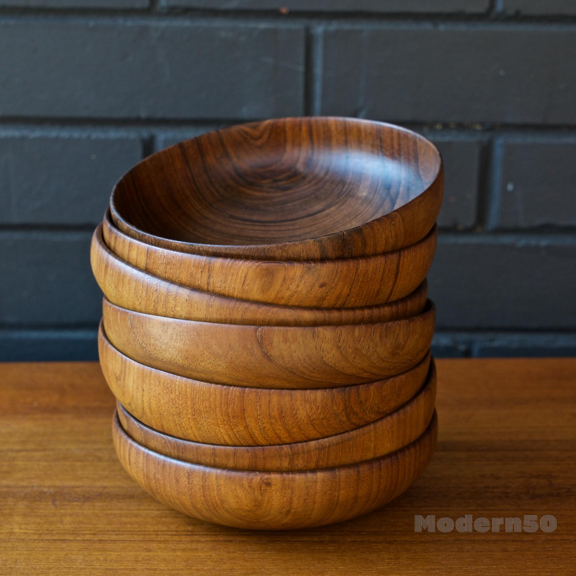 Executed by an unknown craftsman, an amazing set of 7 turned solid teak small bowls. Expertly thin edged, hand done and showing variations to the details in each bowl. No lathe markings, and No foot, an ever so slightly arcing bottom. No label, no