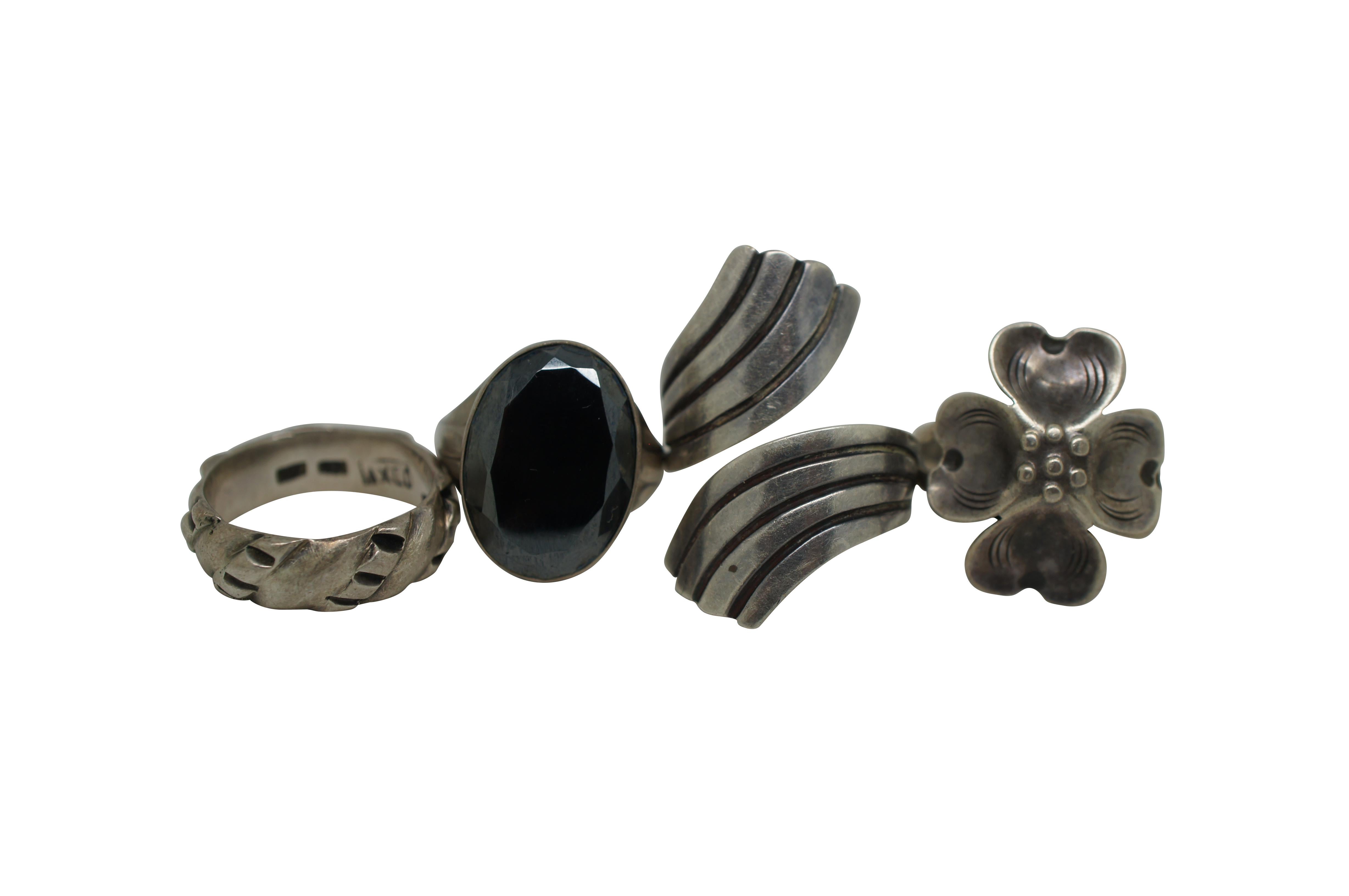Lot of 7 vintage rings in assorted styles and sizes, four sterling silver and three other base metal. Lot includes: adjustable wave shaped, marked EBS, Taxco Hecho en Mexico; Sterling with art deco fan sides and black oval rhinestone; adjustable