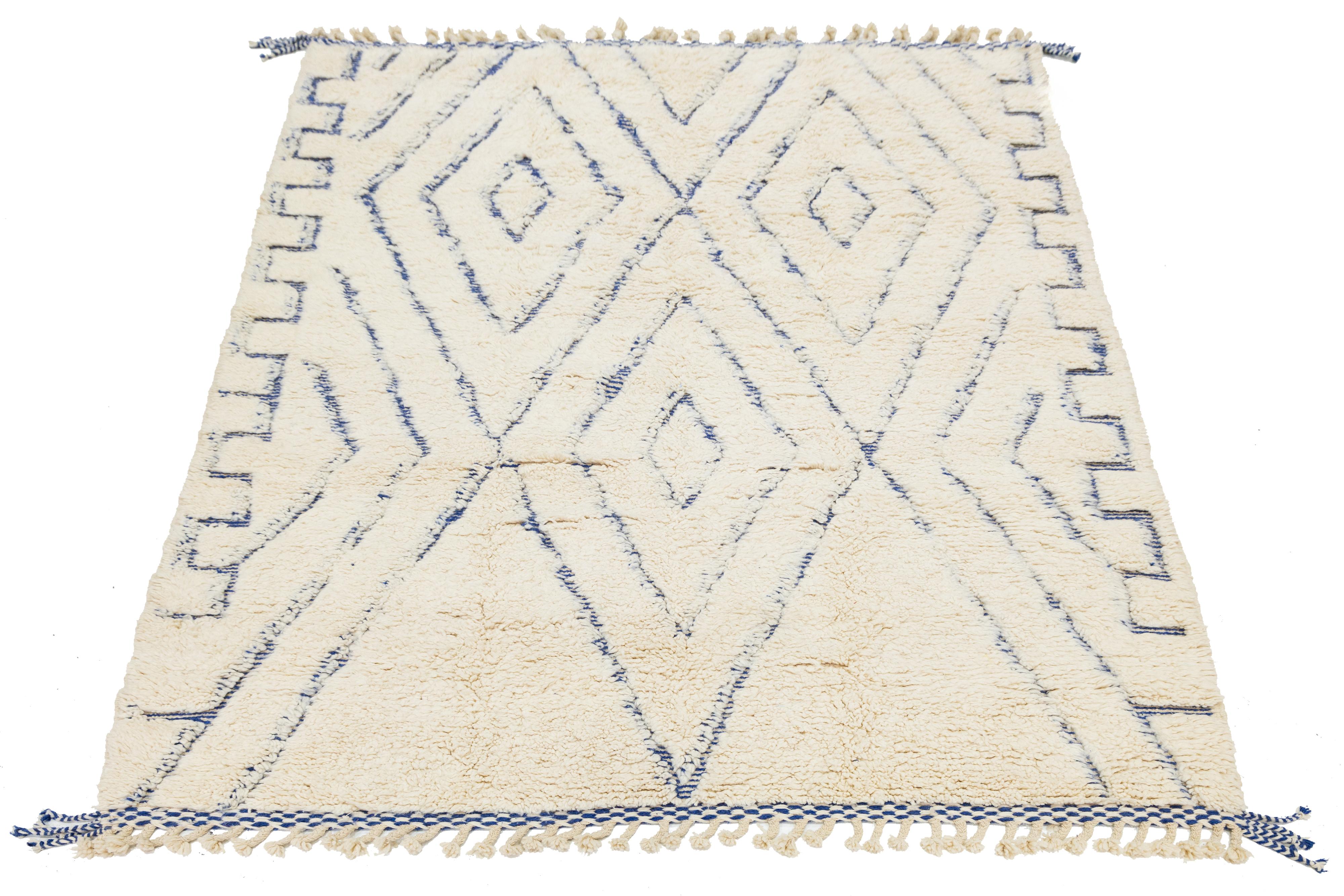 This wool rug exemplifies contemporary Moroccan design through its elegantly designed ivory background. The modern composition features a striking blend of blue, creating a compelling visual impact that is sure to capture attention.

This rug