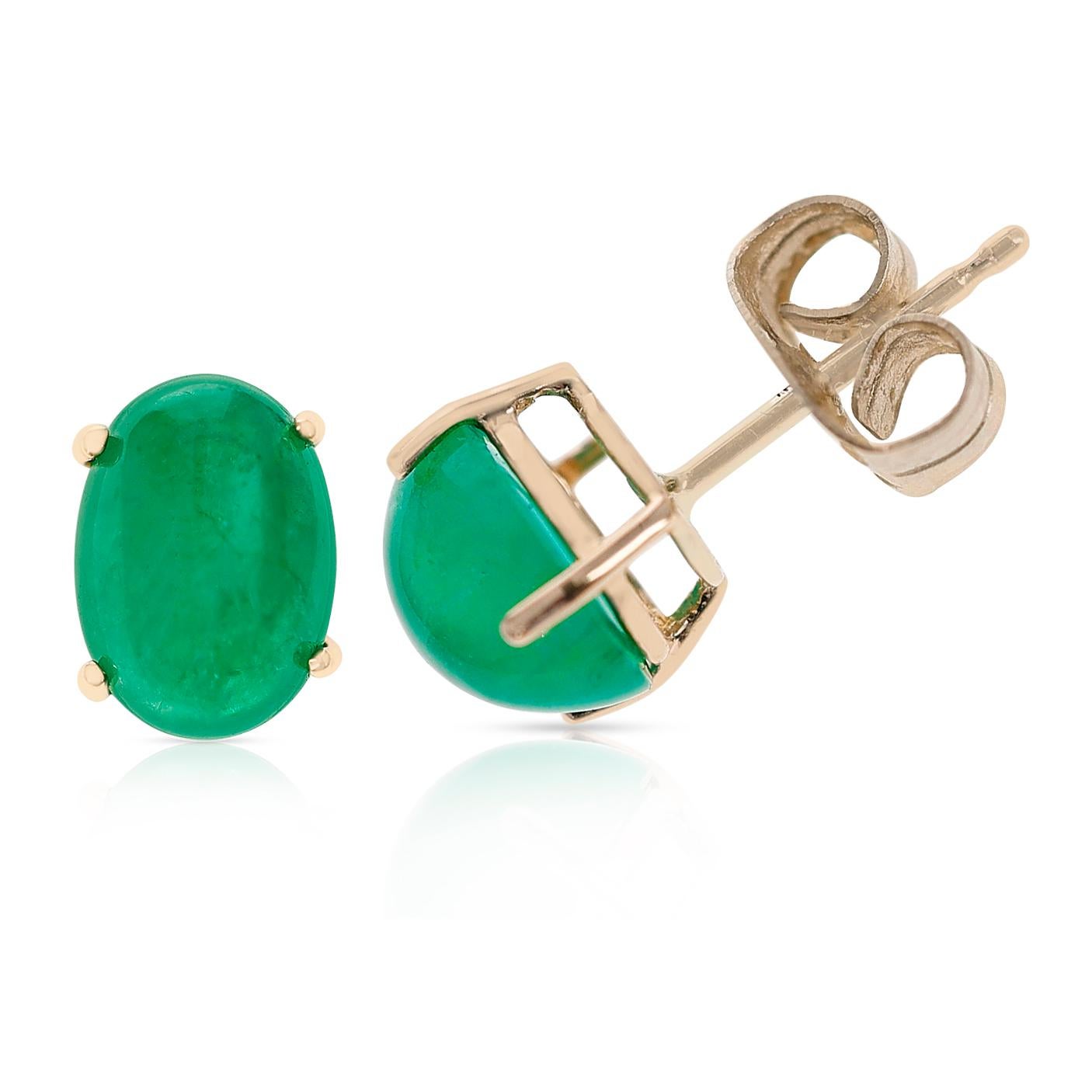 A pair of 7 x 5 MM Emerald Oval Cabochon Stud Earrings made in 14 Karat Yellow Gold. The total stone weight ranges from approximately  1.44 - 1.46 carats.
