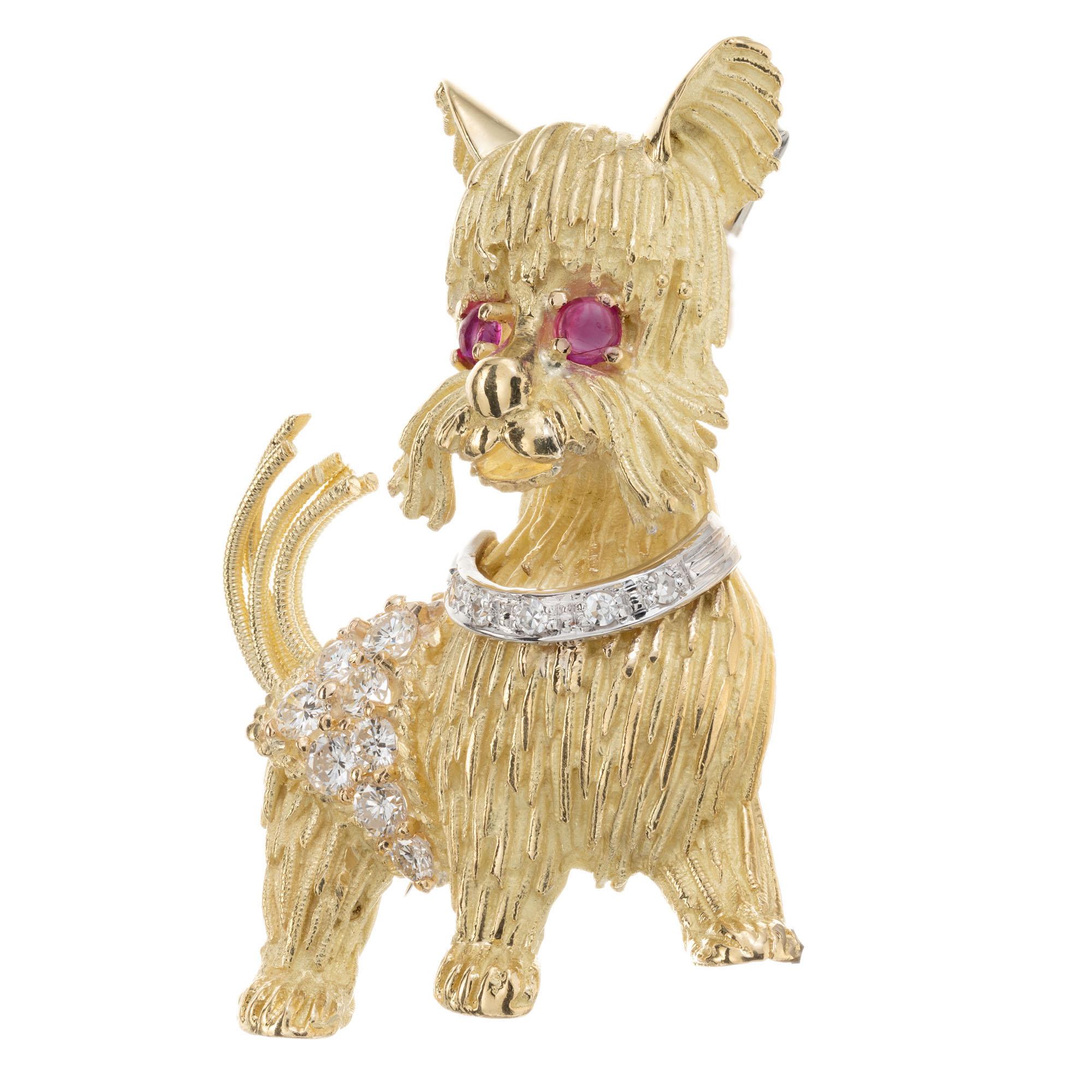 18k yellow gold Yorkie brooch, with ruby eyes and 17 round brilliant cut accent diamonds. Signed HR.

17 round brilliant cut diamonds, G VS-SI approx. .70cts
2 round cabochon red rubies, approx. .12cts
18k yellow gold
18k white gold 
Stamped: K18