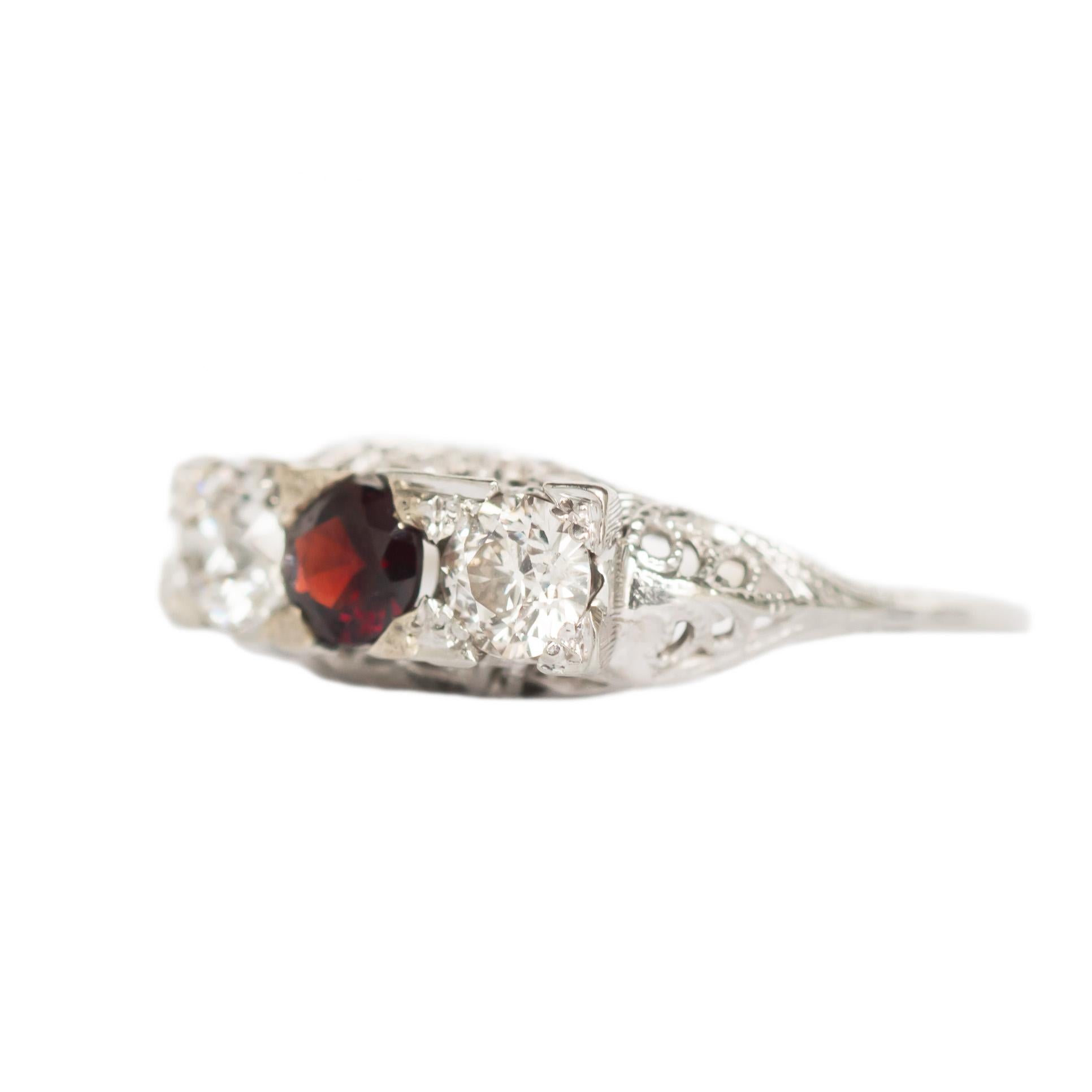 Ring Size: 8.95
Metal Type: 18 karat White Gold 
Weight: 3.5 grams

Color Diamond Details
Type: Natural Garnett
Shape: Round Brilliant 
Carat Weight: .70 carat
Color: Deep Red


Side Stone Details: 
Shape: Old European Brilliant 
Total Carat Weight: